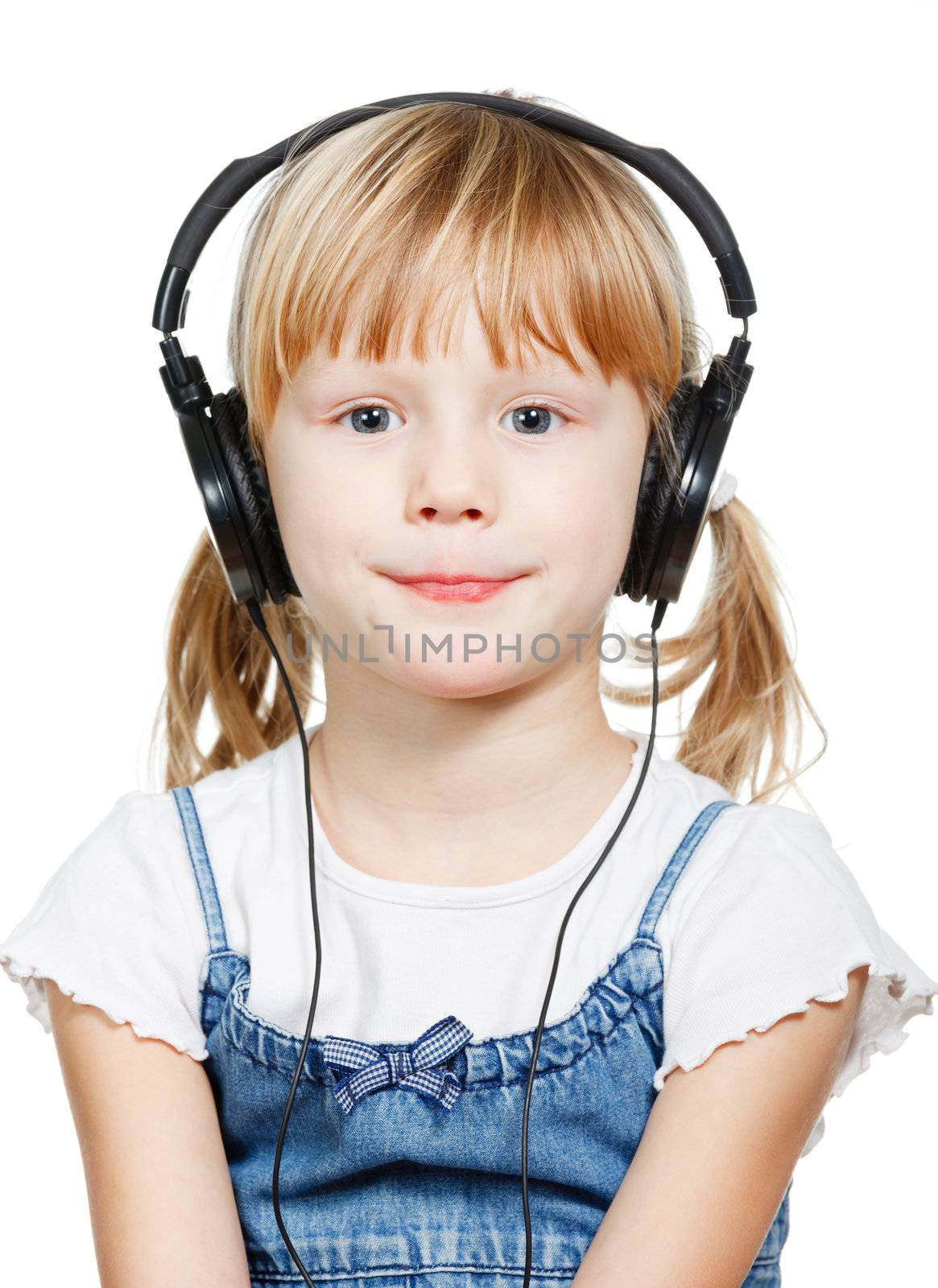 Portrait of cute 4 years girl wearing headphones over a white background