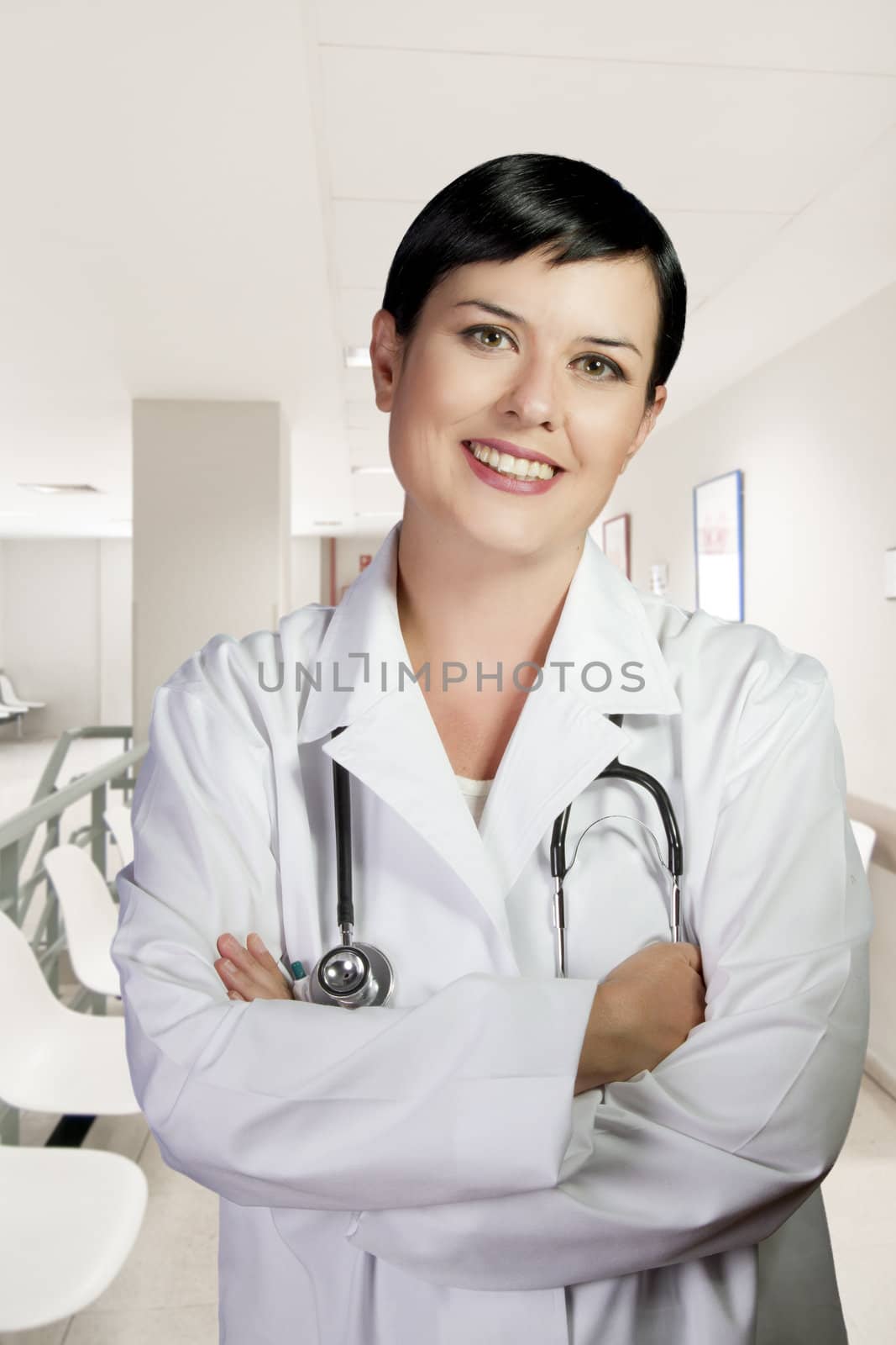 Woman with lab coat and stethoscope in a business environment
