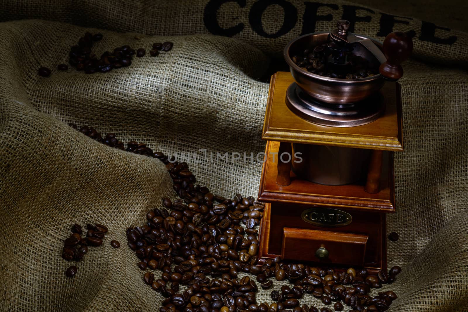 Coffee Mill with beans and burlap. still life