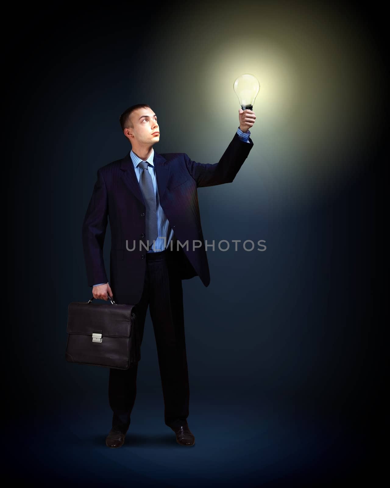 Businessman with light shining by sergey_nivens