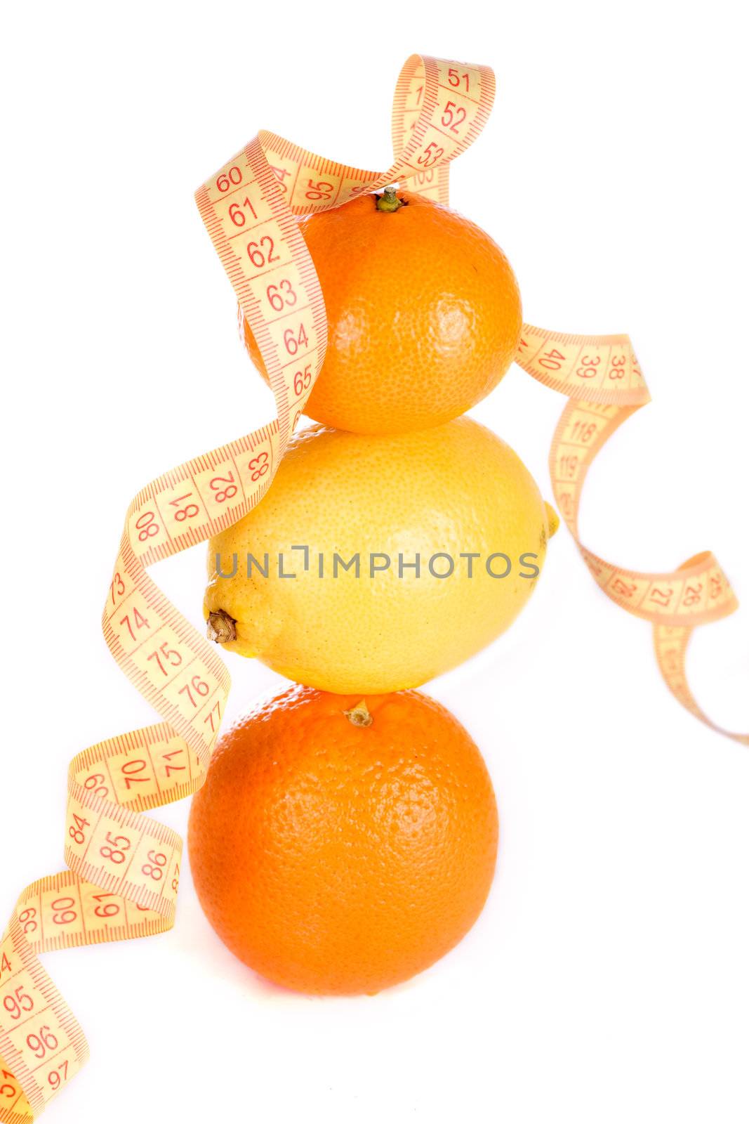 Weight loss and healthy dieting concept. Orange, lemon and mandarin with measure tape. Isolated over white..
