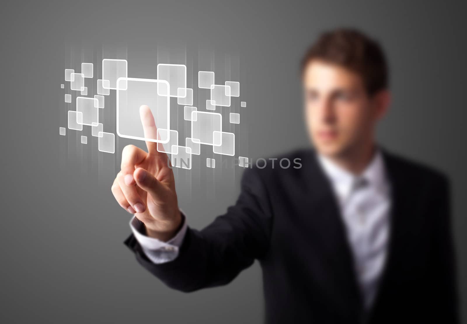 Businessman pressing high tech type of modern buttons on a virtual background