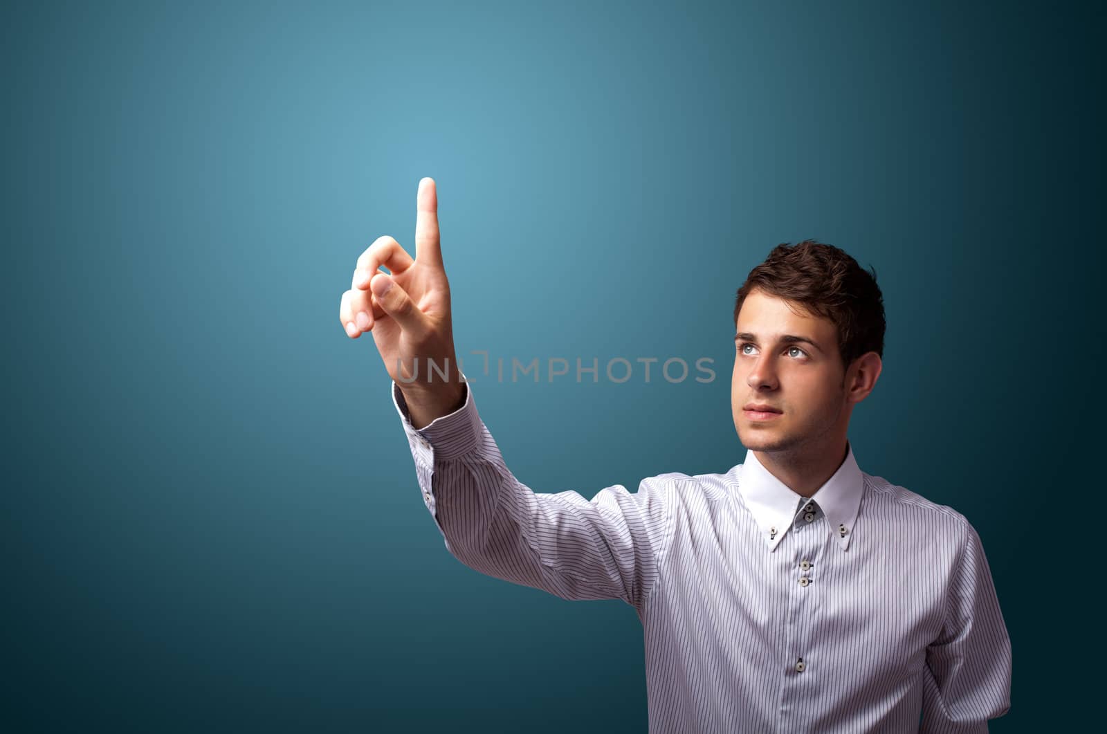 Businessman pressing an imaginary button on bokeh 