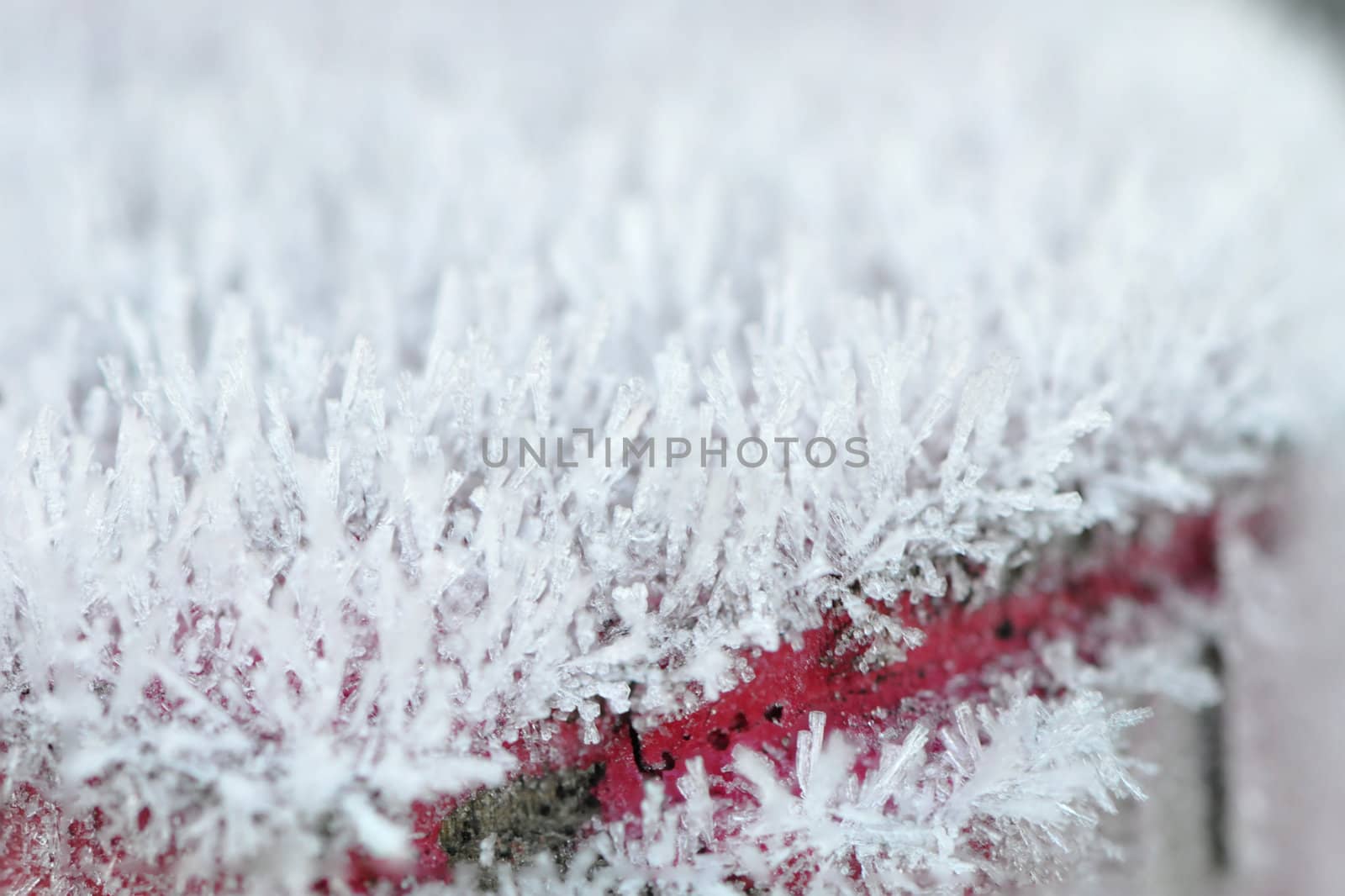 Lot of Frost on a Picket with a Red Line and a blurred effect