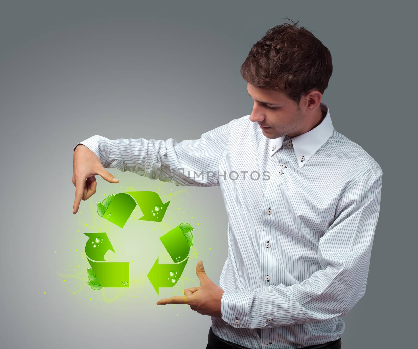 Young businessman holding virtual eco sign