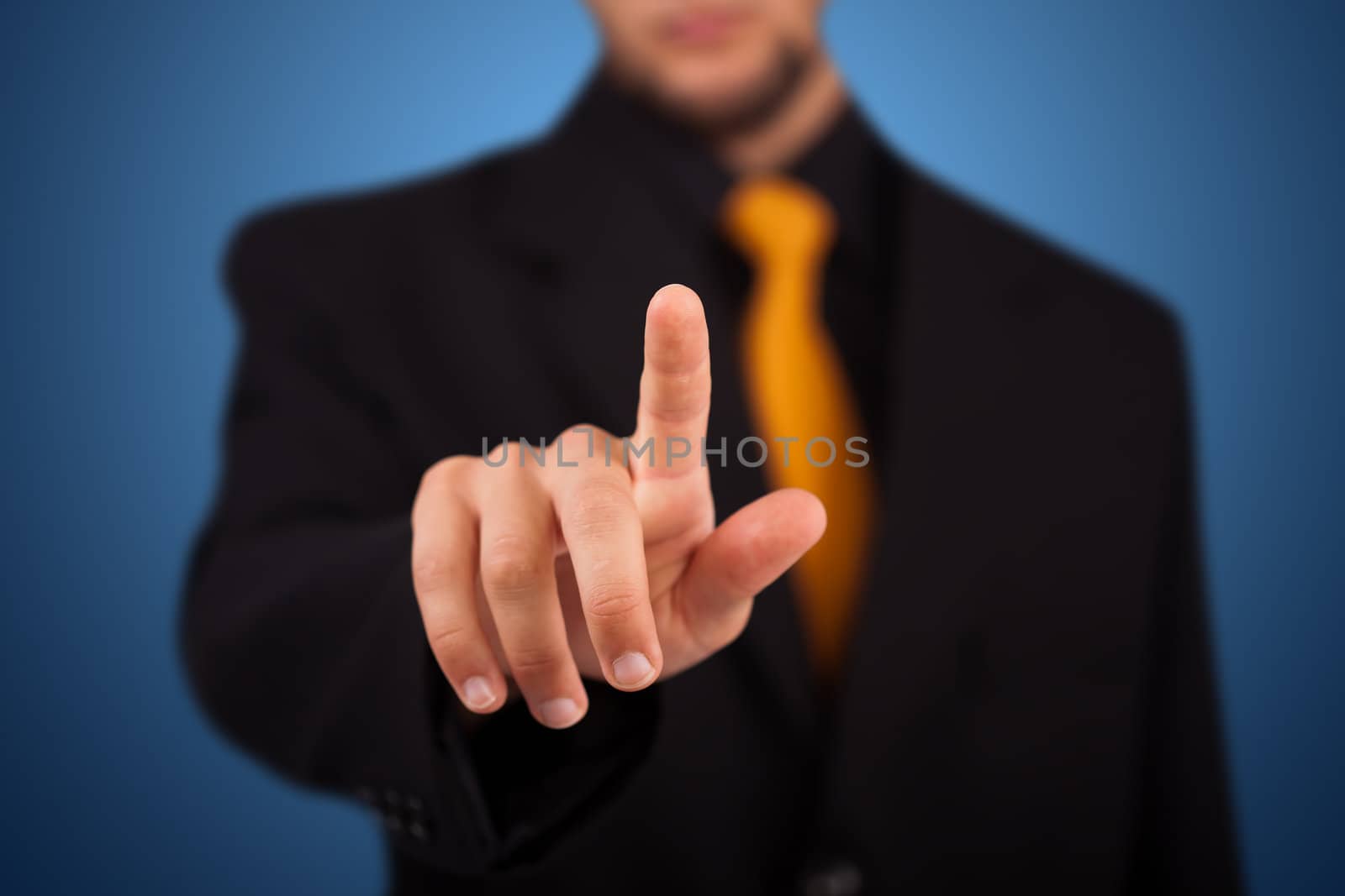 Businessman pressing an imaginary button on bokeh 