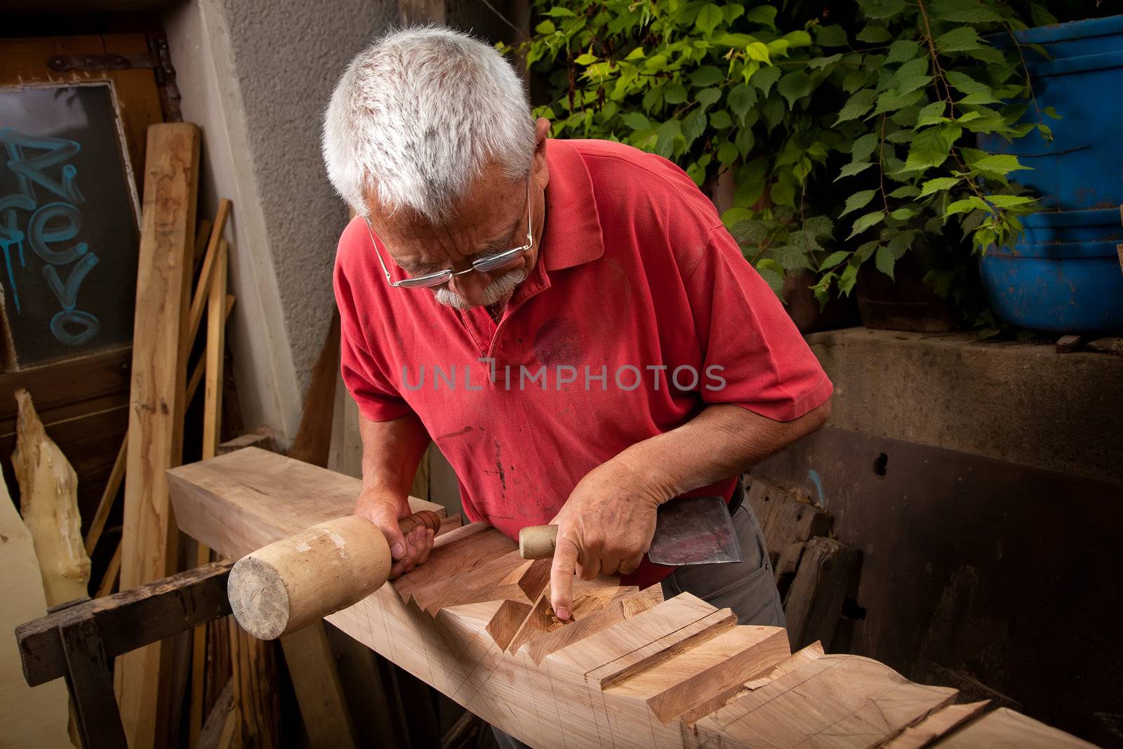 woodcarver working with mallet and chisel 7 by ra2studio