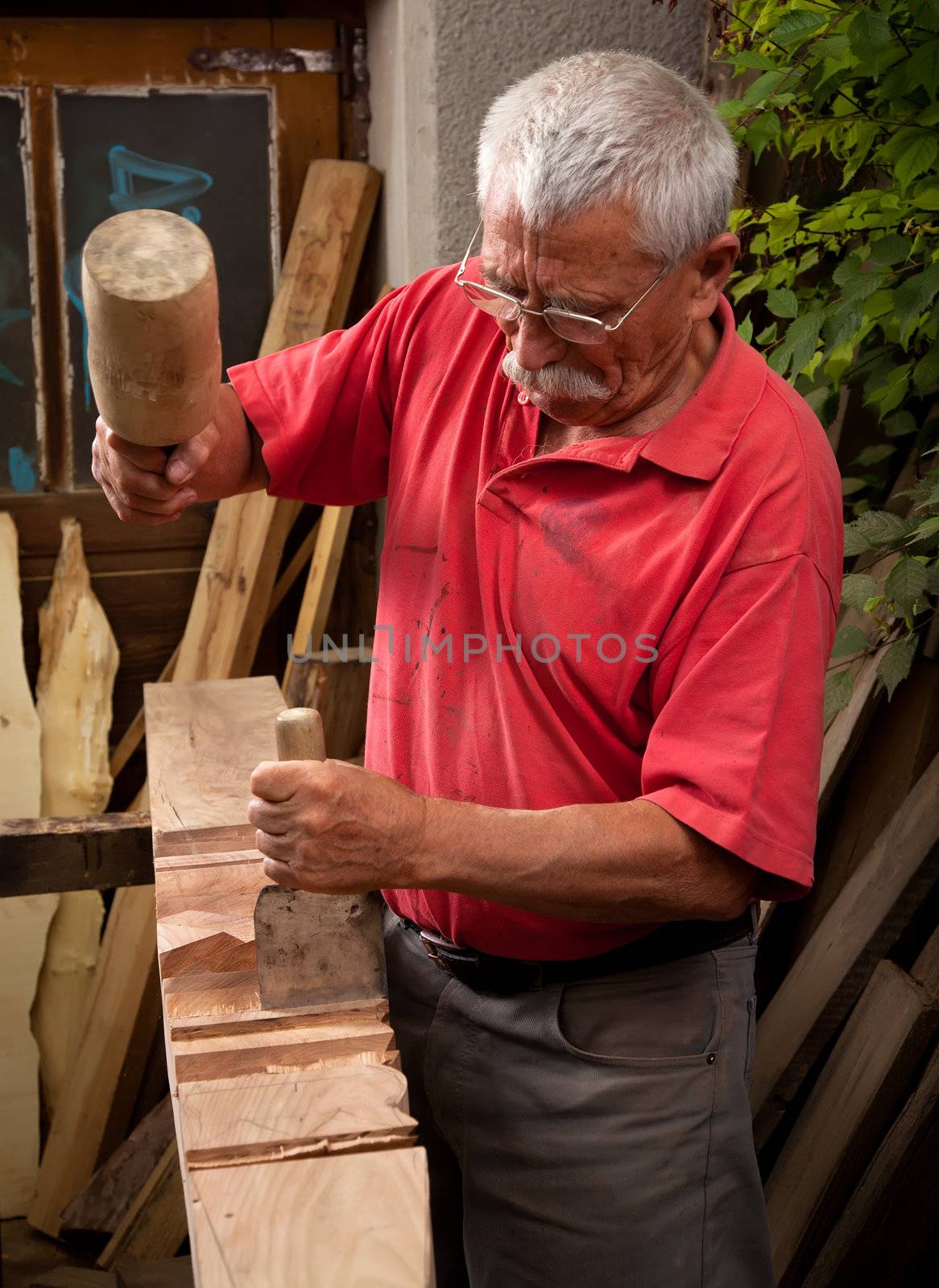 woodcarver working with mallet and chisel 2 by ra2studio