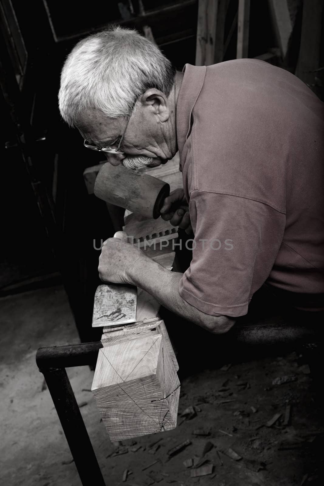 woodcarver working with mallet and chiesel  by ra2studio