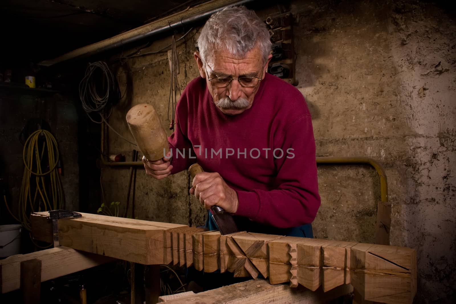 Old woodcarver work in the workshop 1