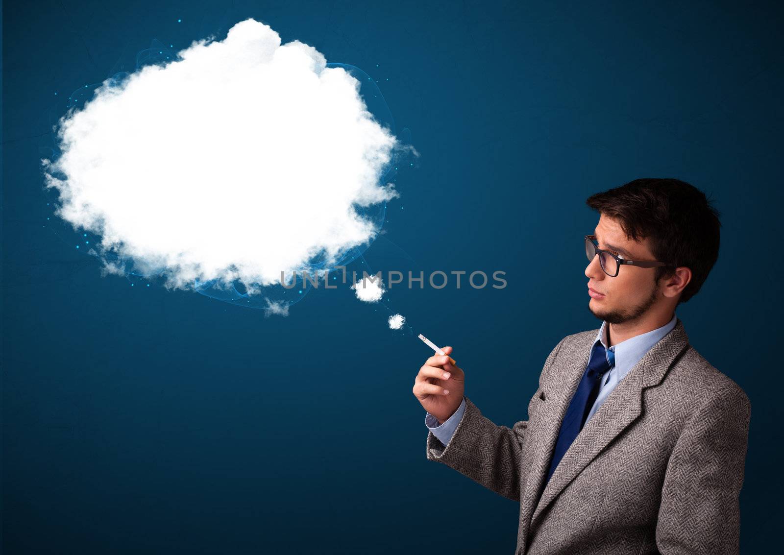 Handsome young man smoking unhealthy cigarette with dense smoke