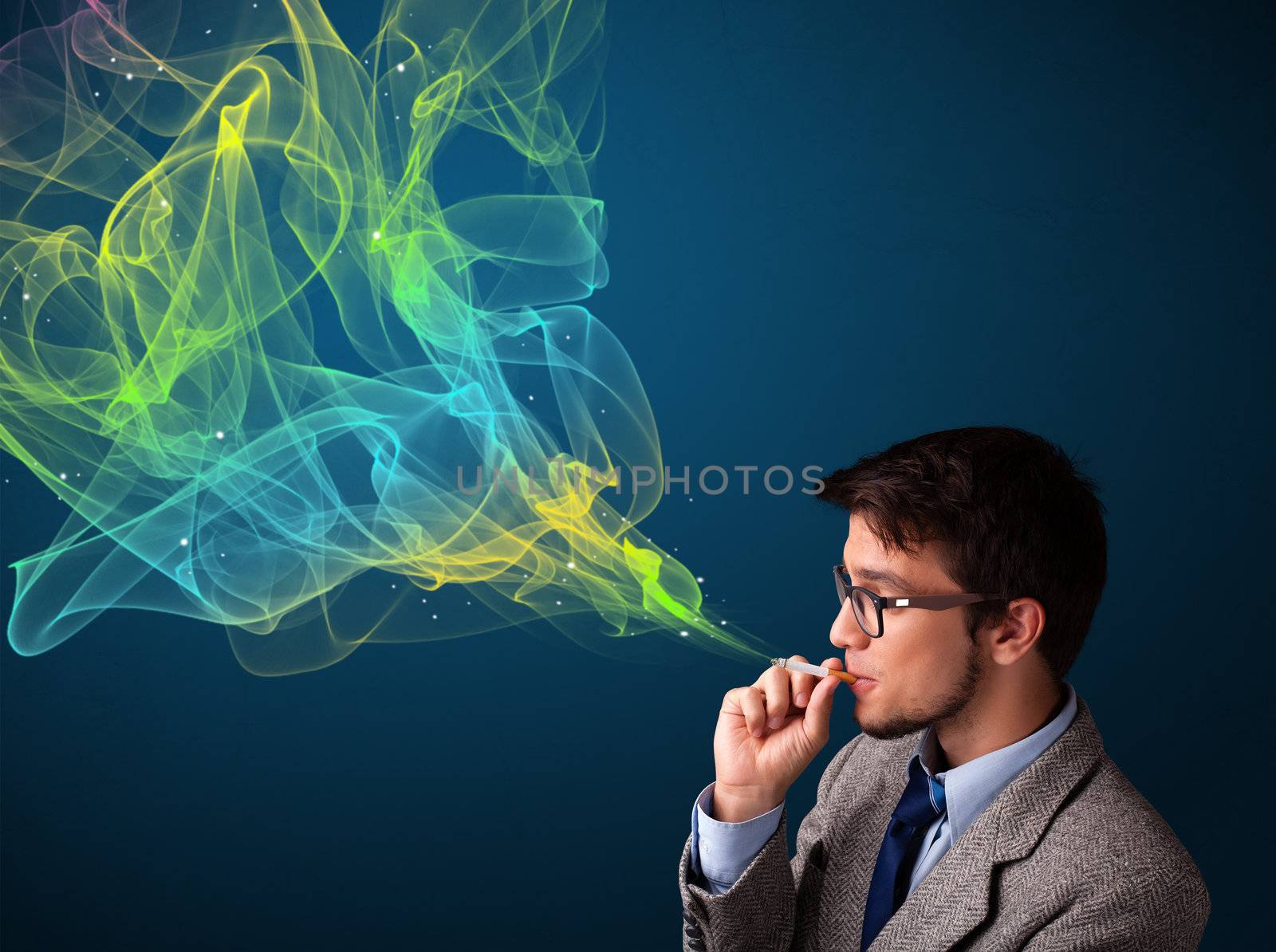 Handsome young man smoking cigarette with colorful smoke