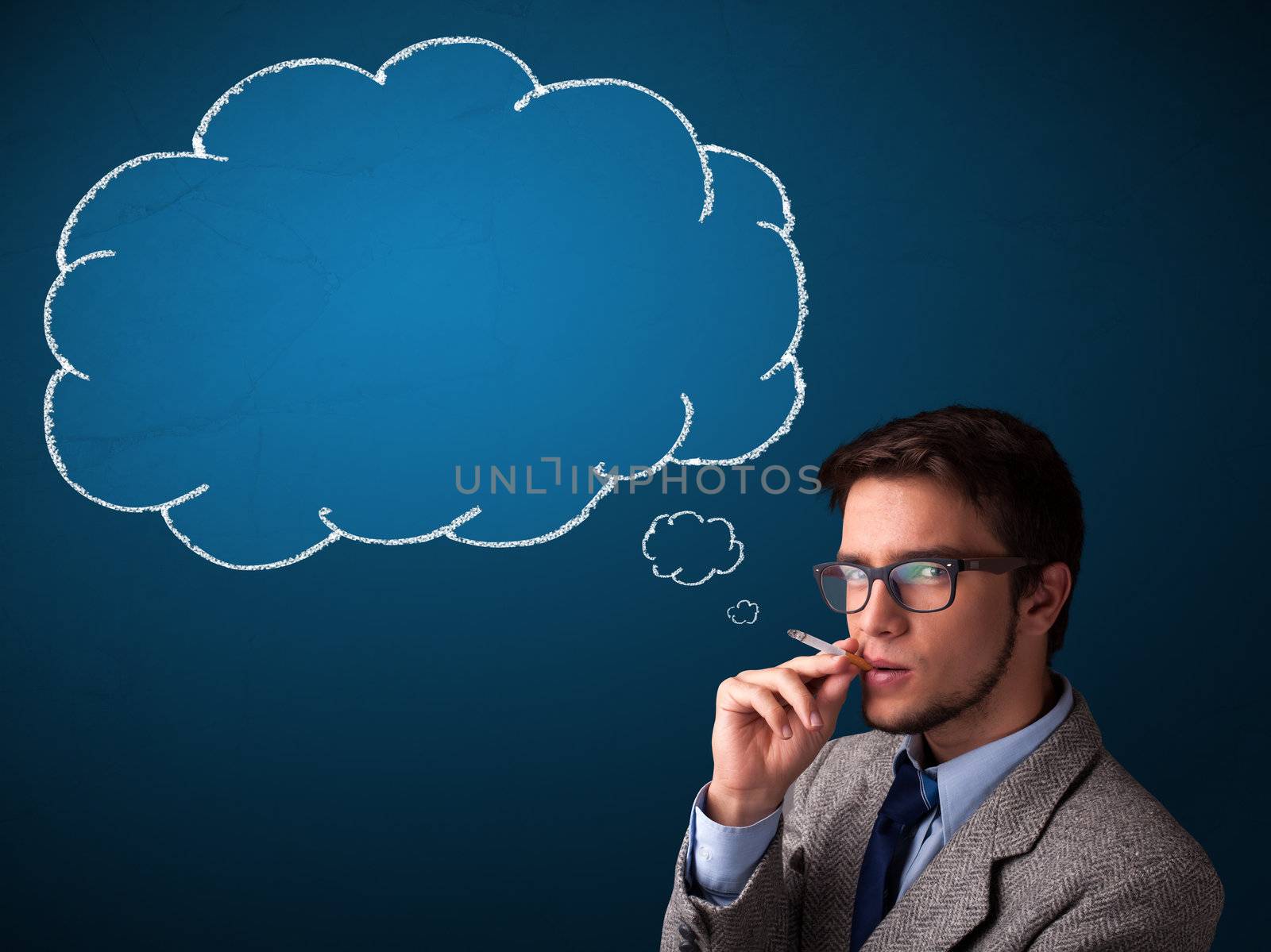 Attractive young man smoking cigarette with idea cloud