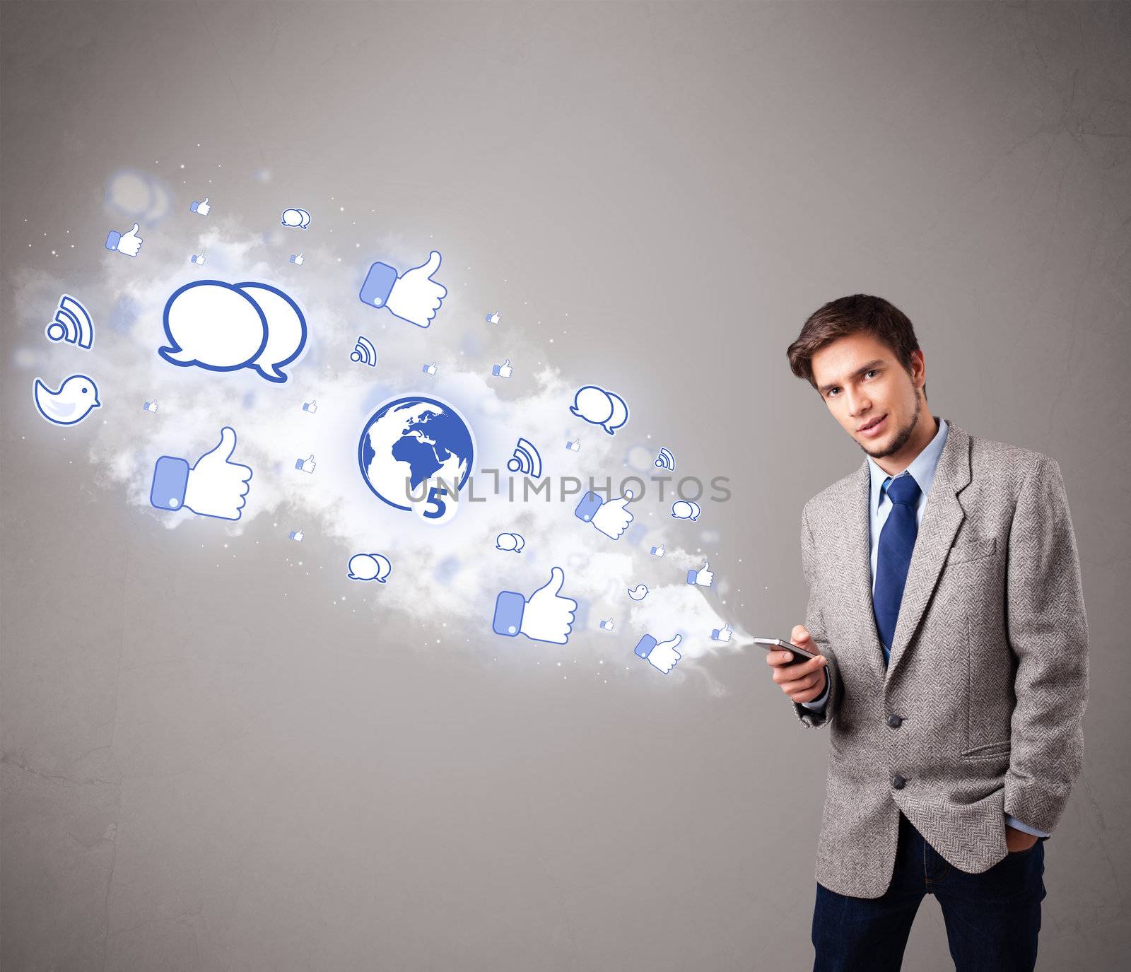 attractive young man holding a phone with social media icons by ra2studio