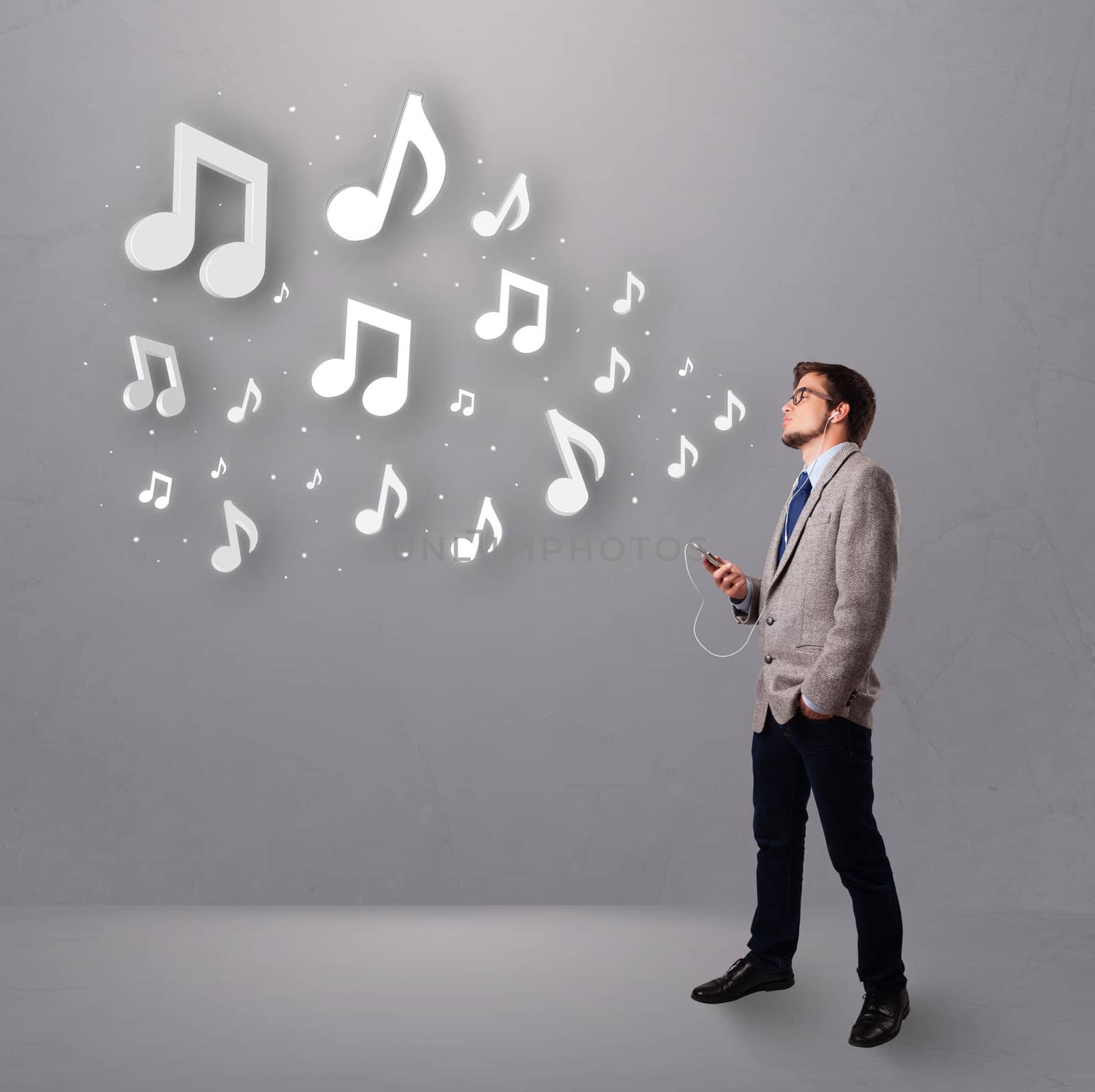 attractive young man singing and listening to music with musical notes getting out of his mouth