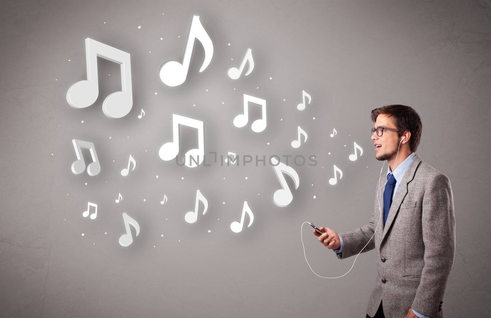 attractive young man singing and listening to music with musical notes getting out of his mouth