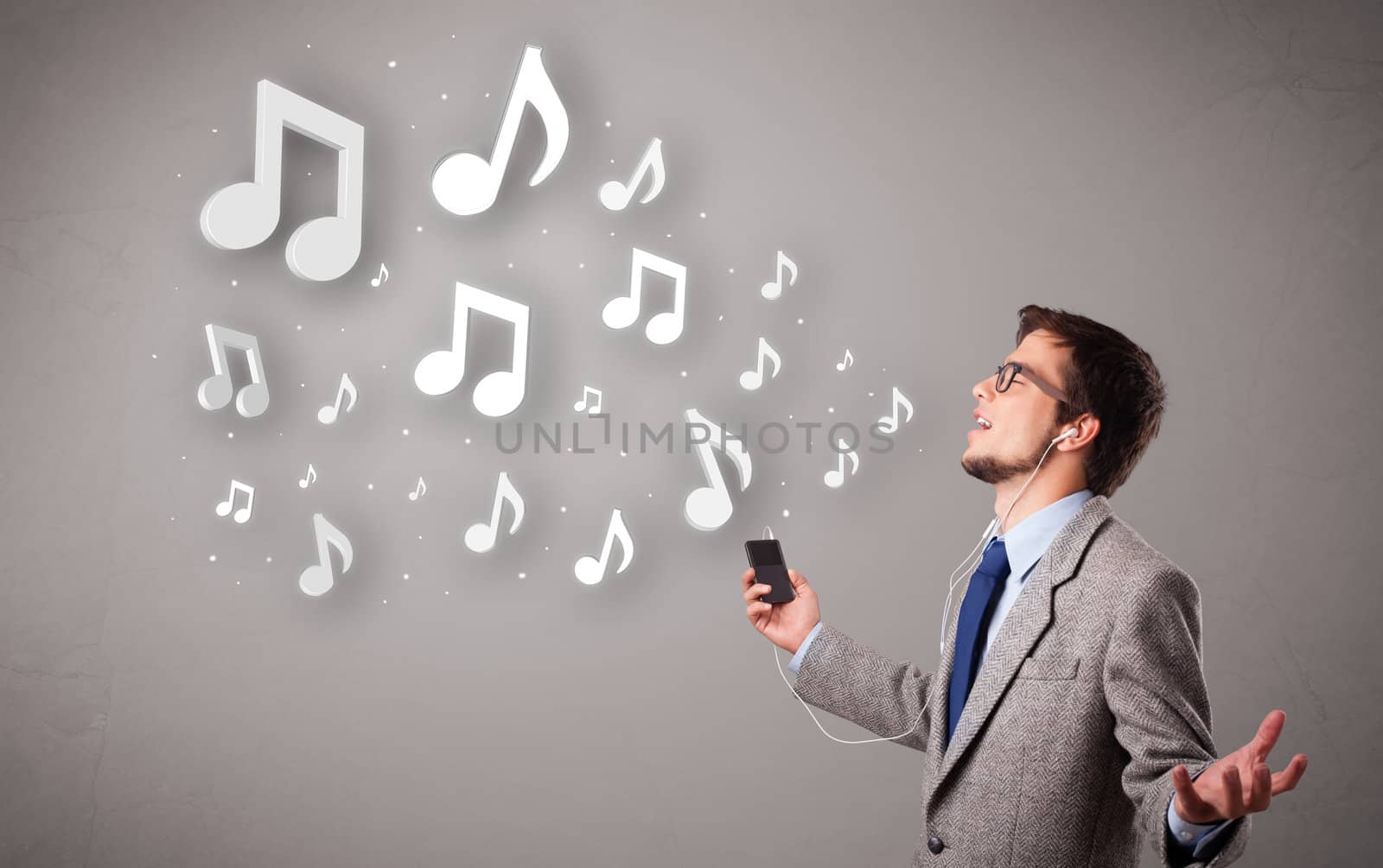 attractive young man singing and listening to music with musical notes getting out of his mouth