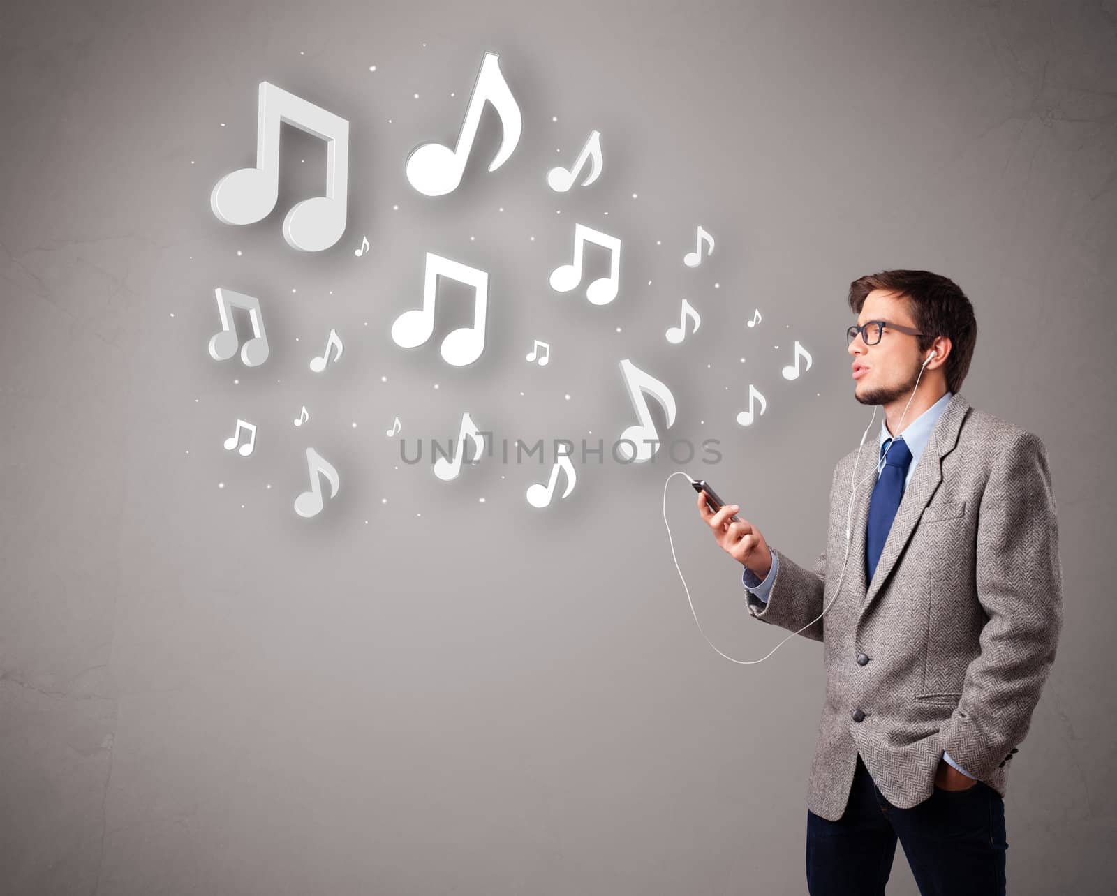 attractive young man singing and listening to music with musical notes getting out of his mouth