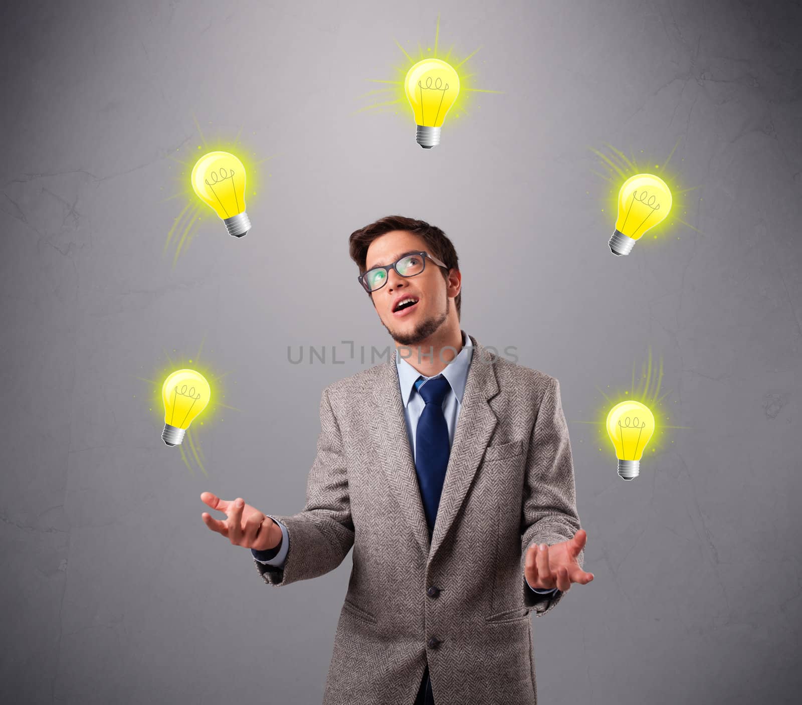 funny young man standing and juggling with light bulbs
