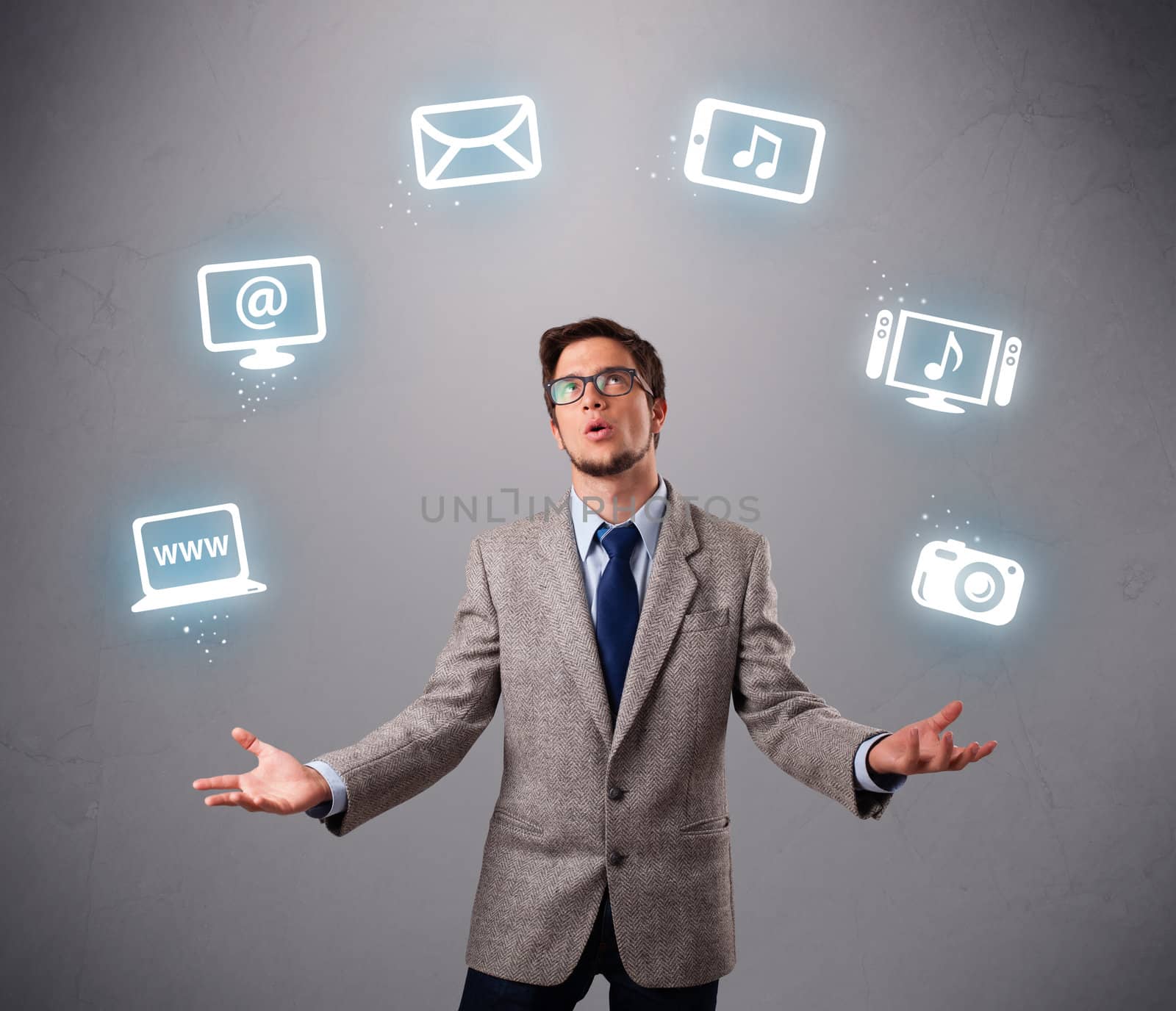 funny boy standing and juggling with electronic devices icons