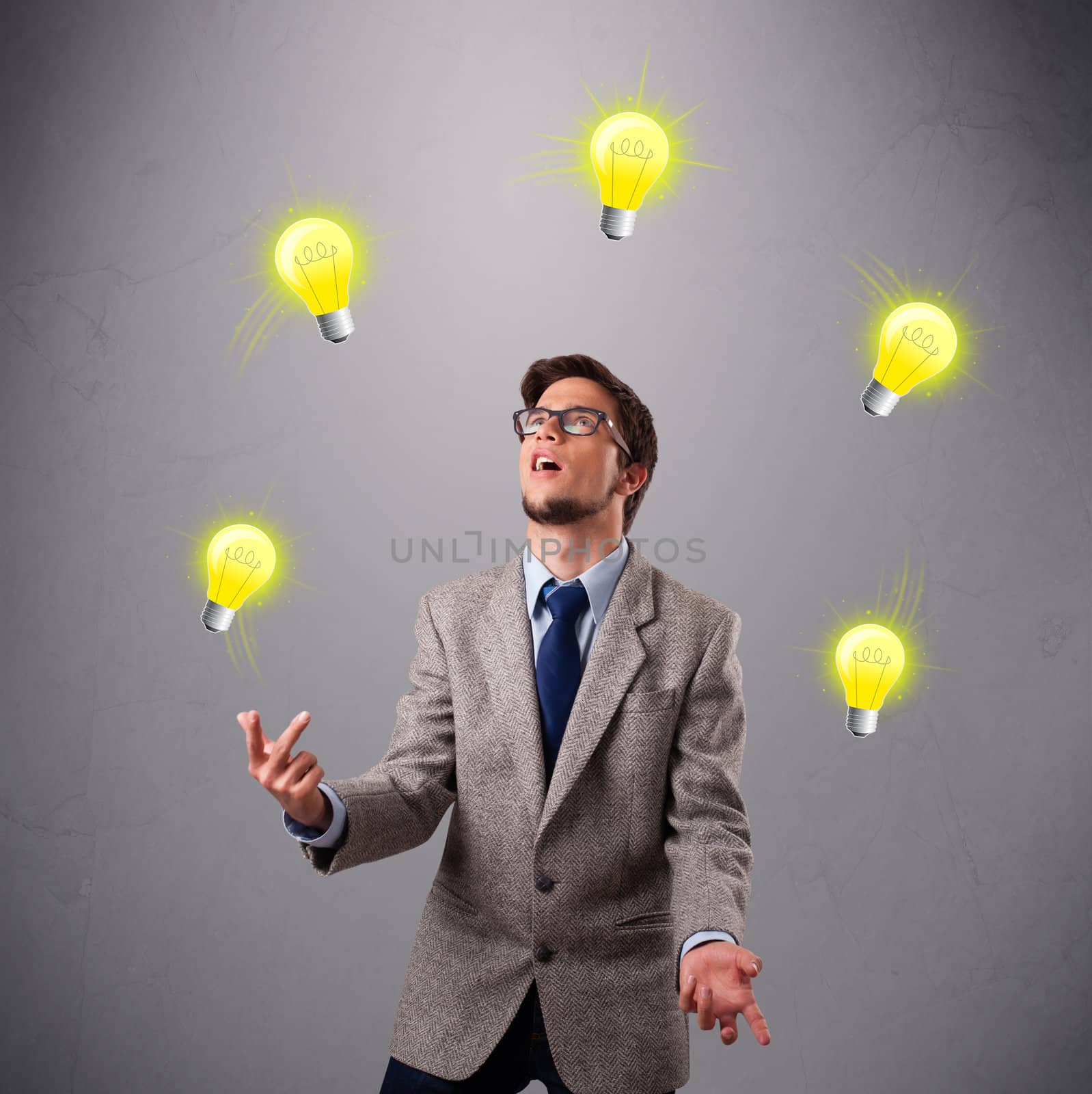 young man standing and juggling with light bulbs by ra2studio