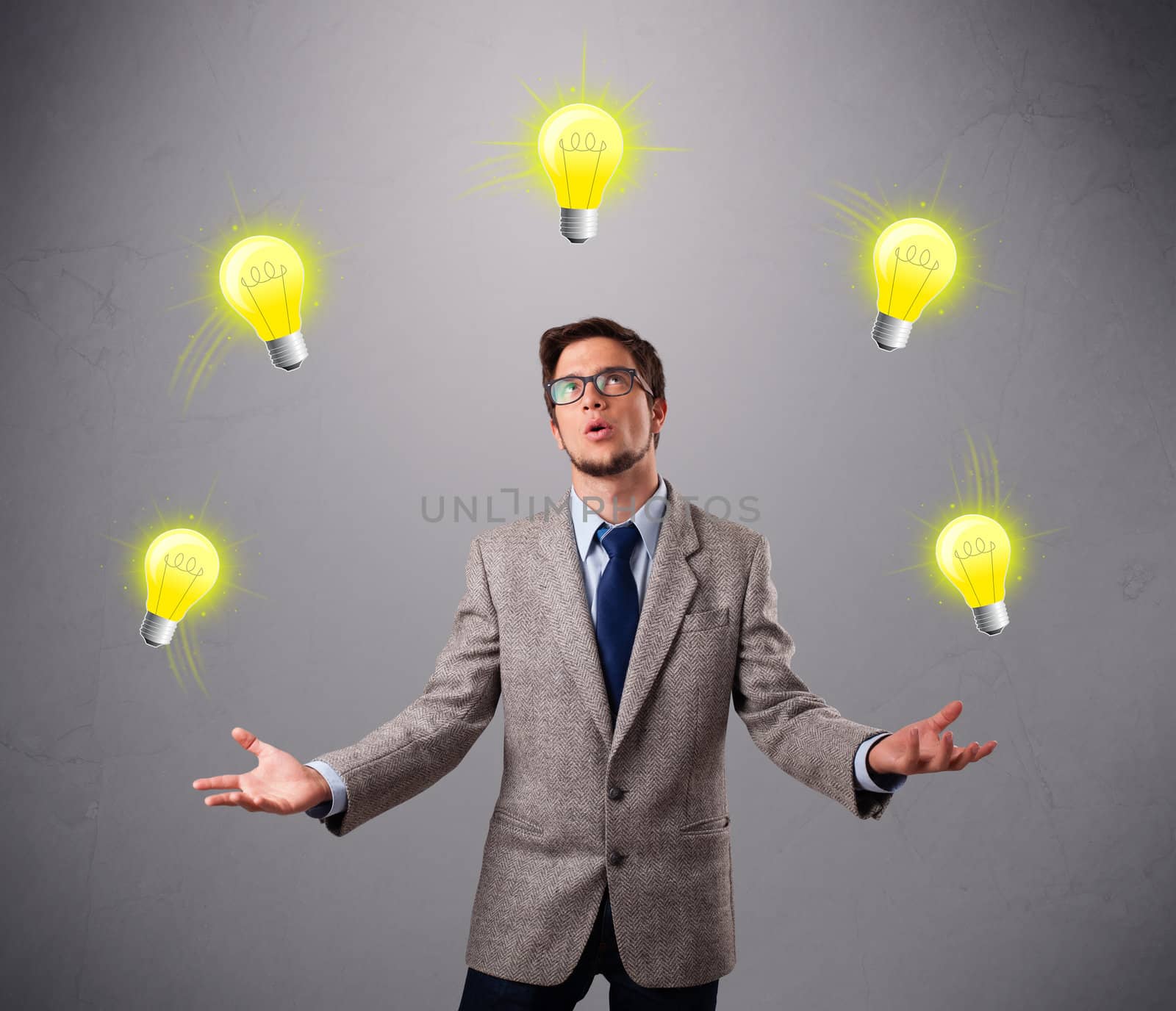 young man standing and juggling with light bulbs by ra2studio