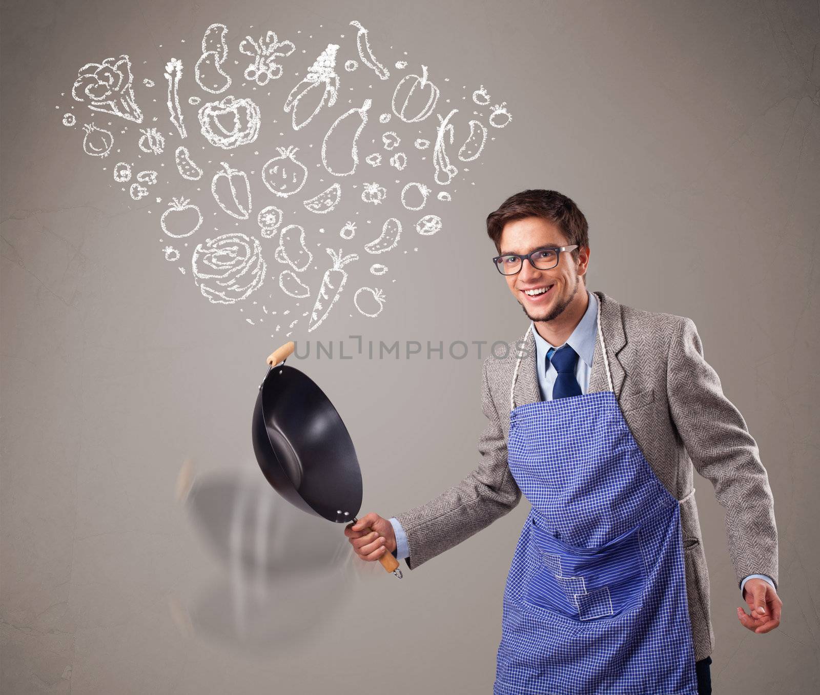 Attractive young man cooking vegetables