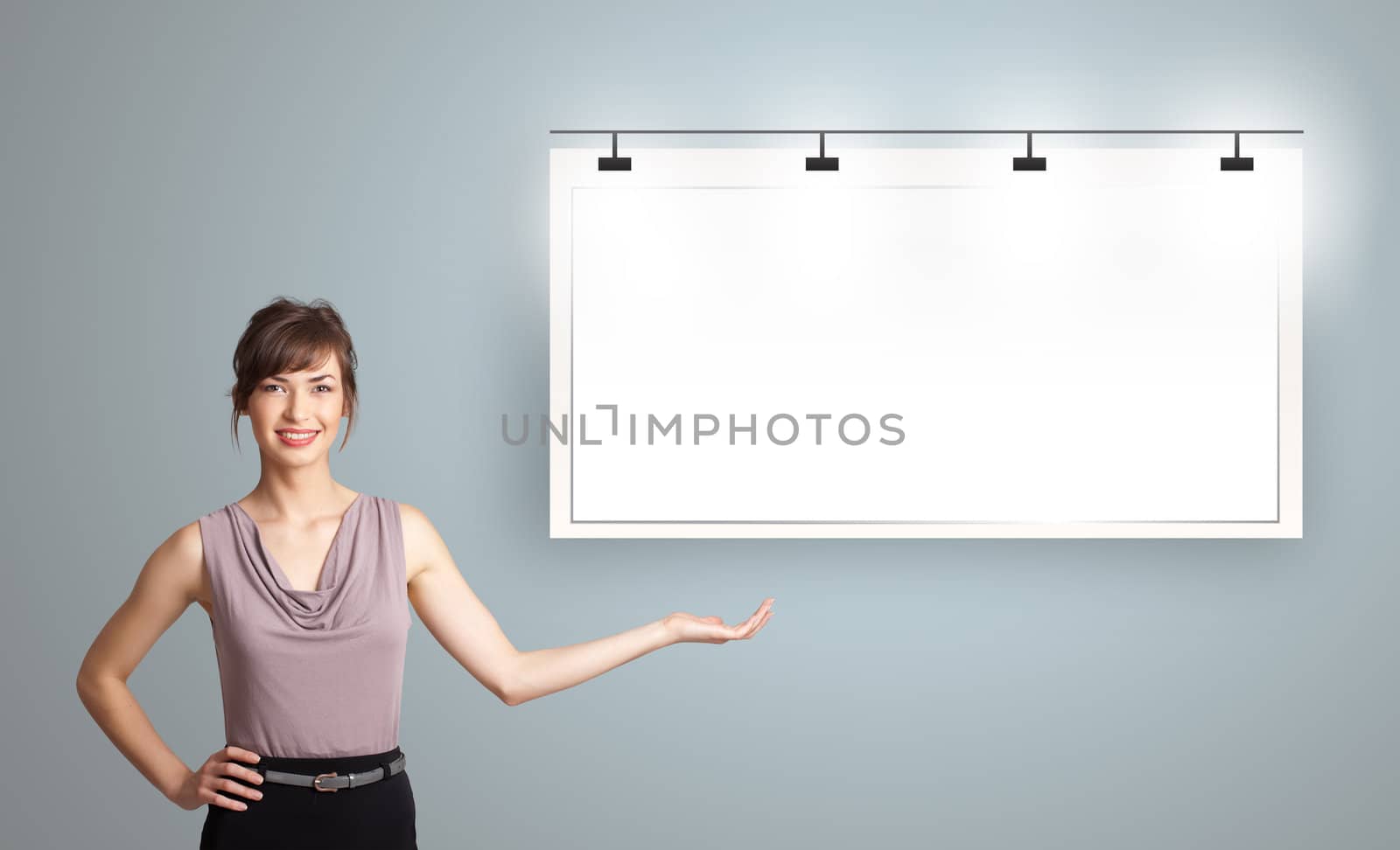 Beautiful young woman presenting modern copy space