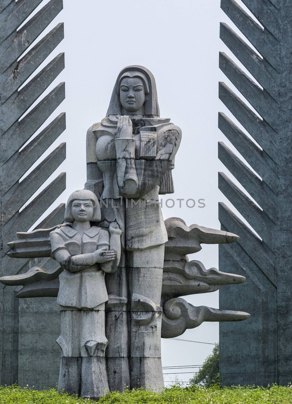 Sad looking woman conforts child while looking to North Vietnam.