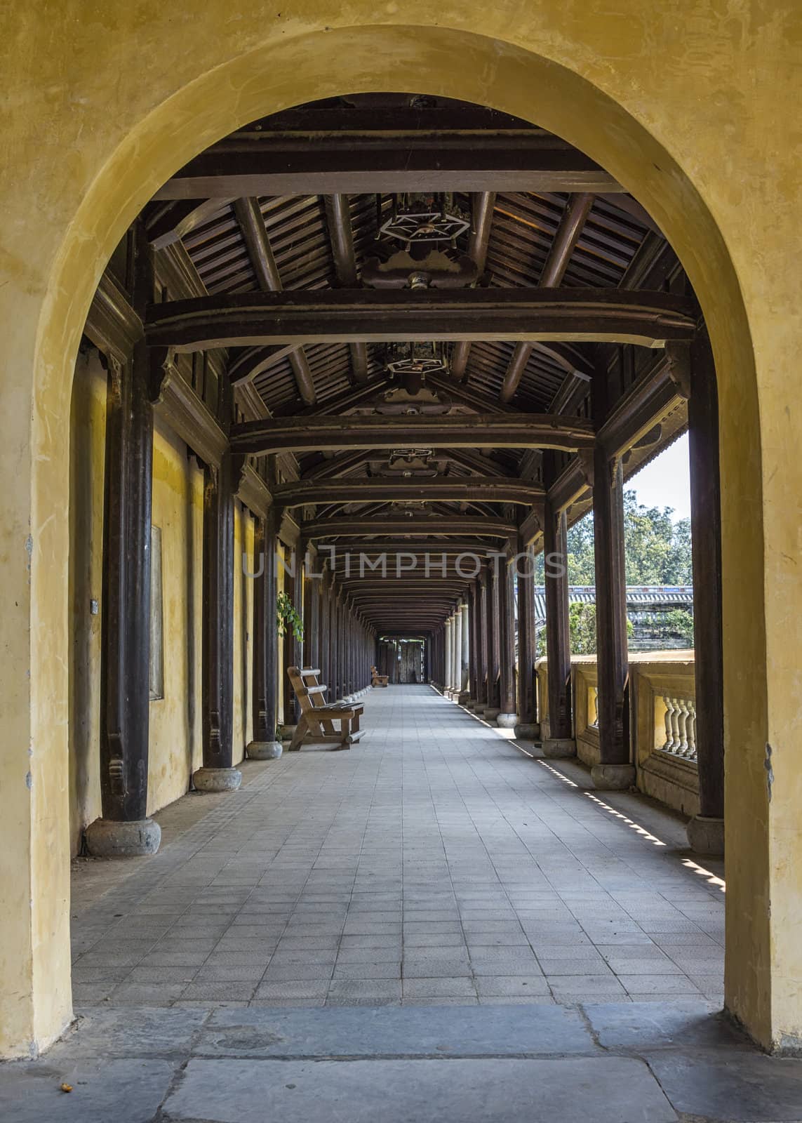Vietnam Hué Citadel: long view into covered hallway with open s by Claudine