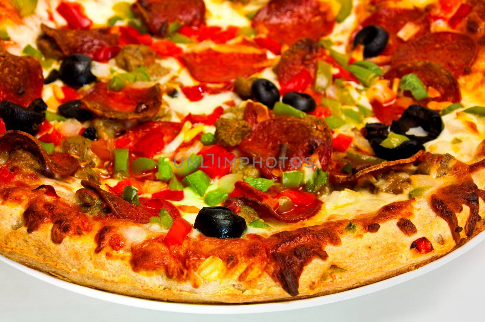 Supreme Pizza with tomato, cheese, pepperoni, black olives, green and red peppers.