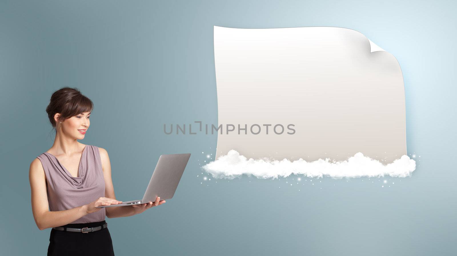Attractive young woman holding a laptop and presenting modern copy space on clouds