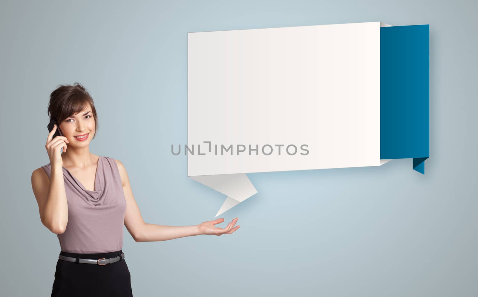 pretty young woman standing next to modern origami copy space and making phone call