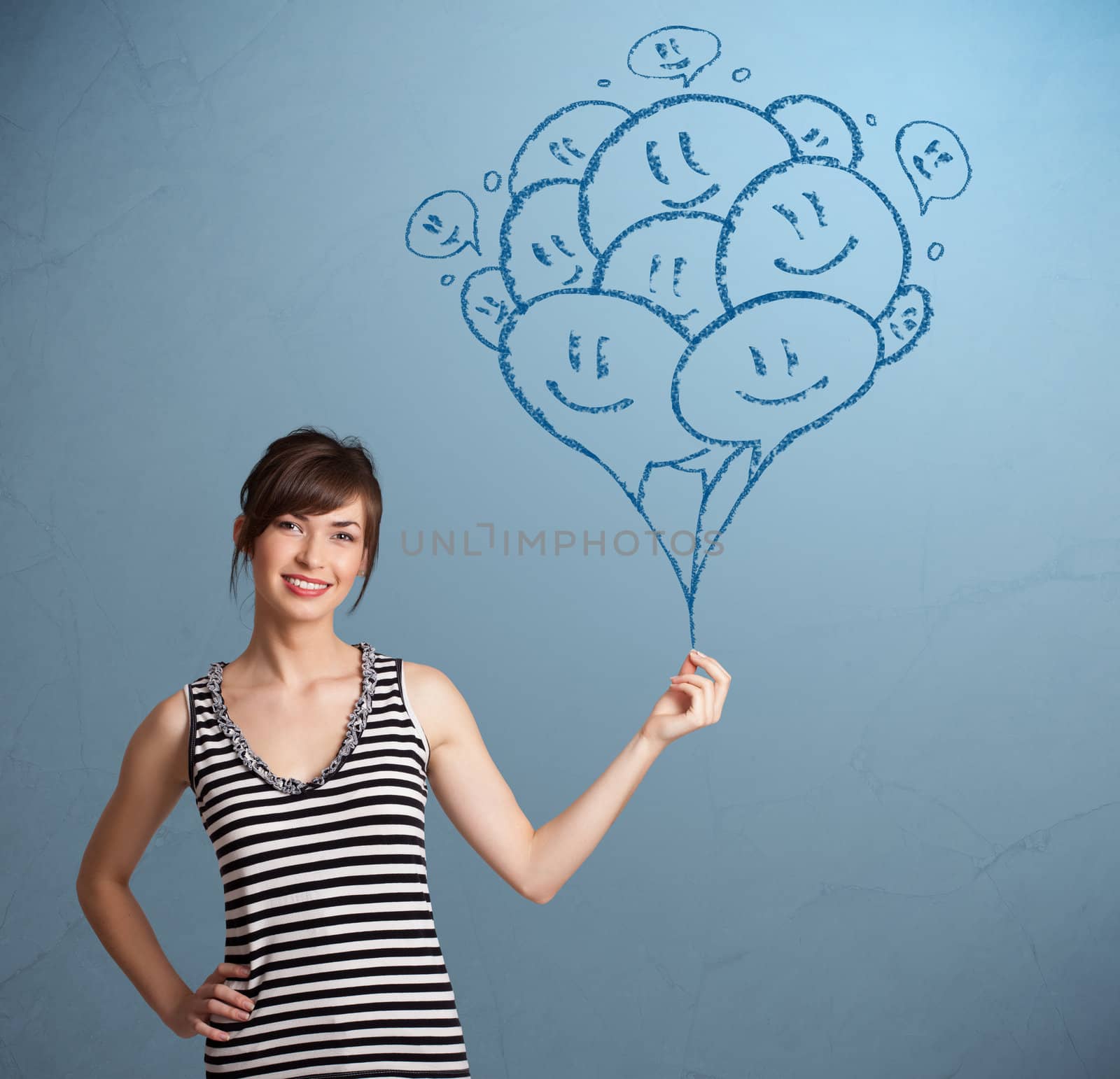 Happy young woman holding smiling balloons drawing