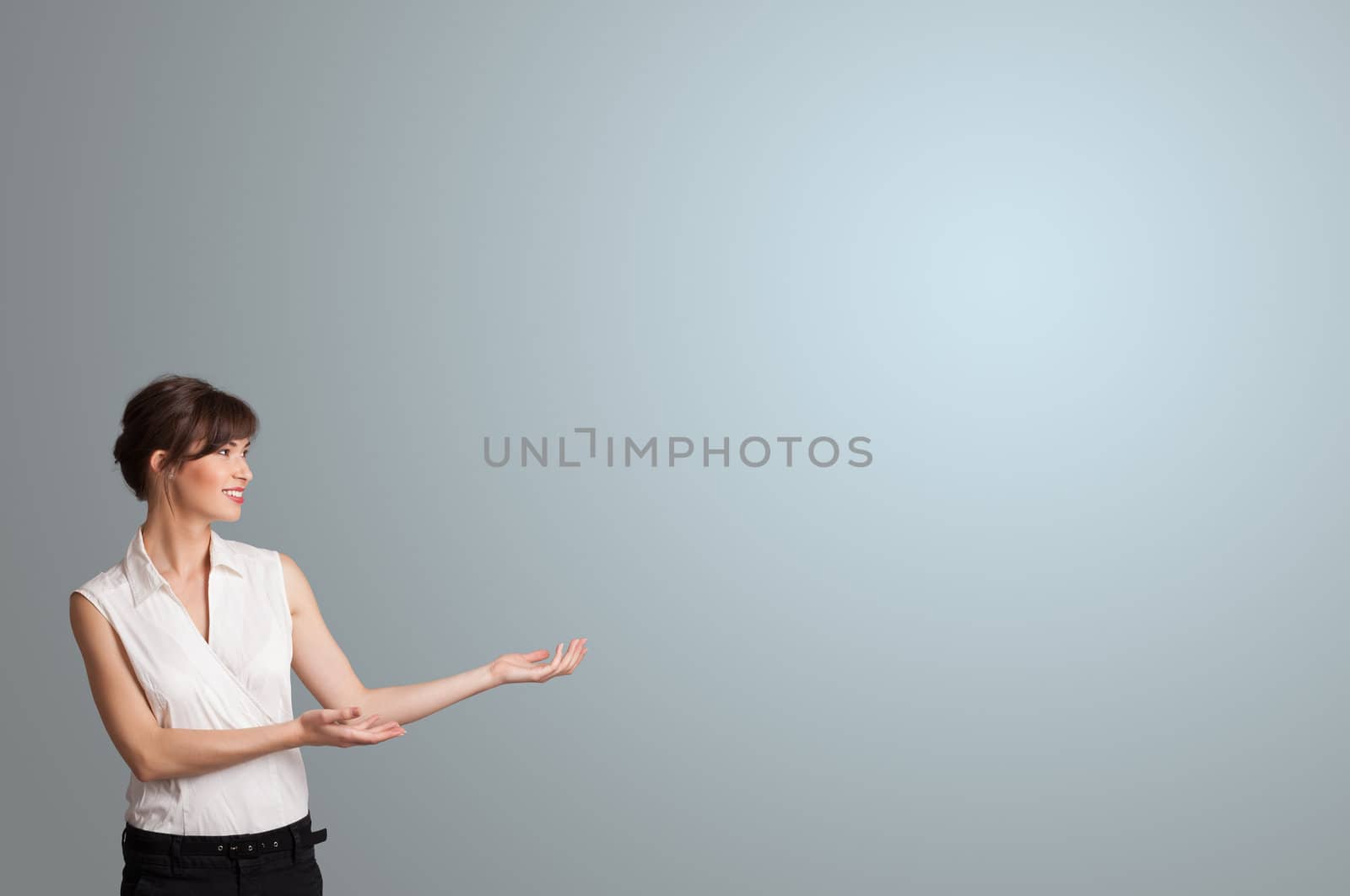 Pretty young woman presenting copy space