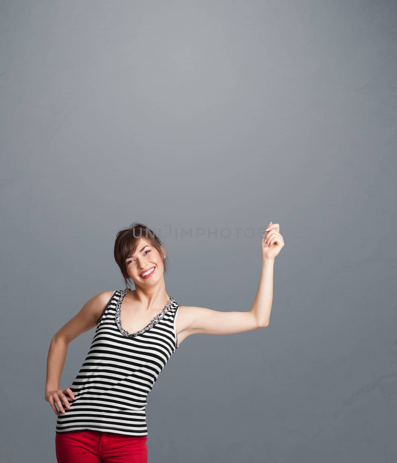 Pretty young lady gesturing with copy space