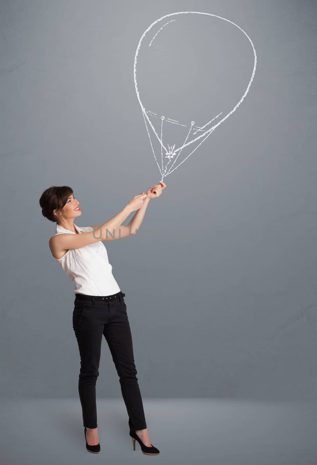 Beautiful young woman holding balloon drawing