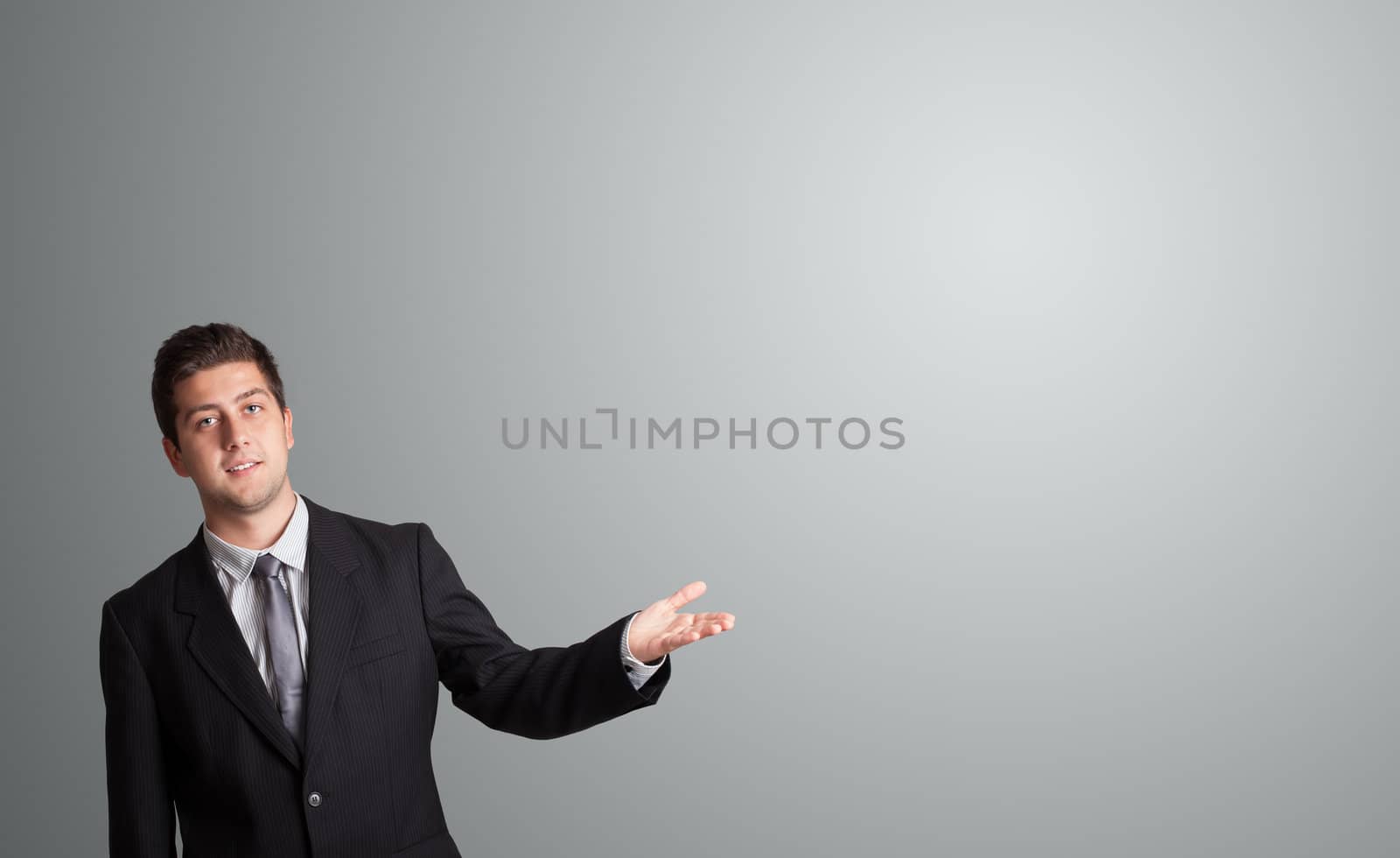 handsome young man presenting copy space
