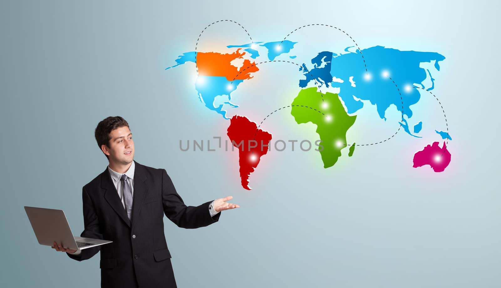 young man holding a laptop and presenting colorful world map by ra2studio