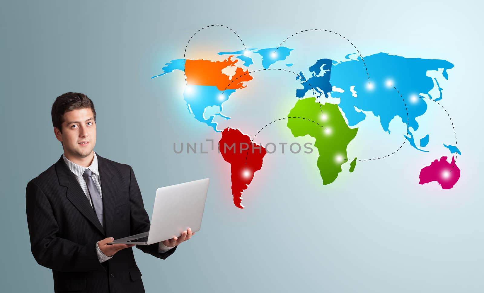 young man holding a laptop and presenting colorful world map by ra2studio