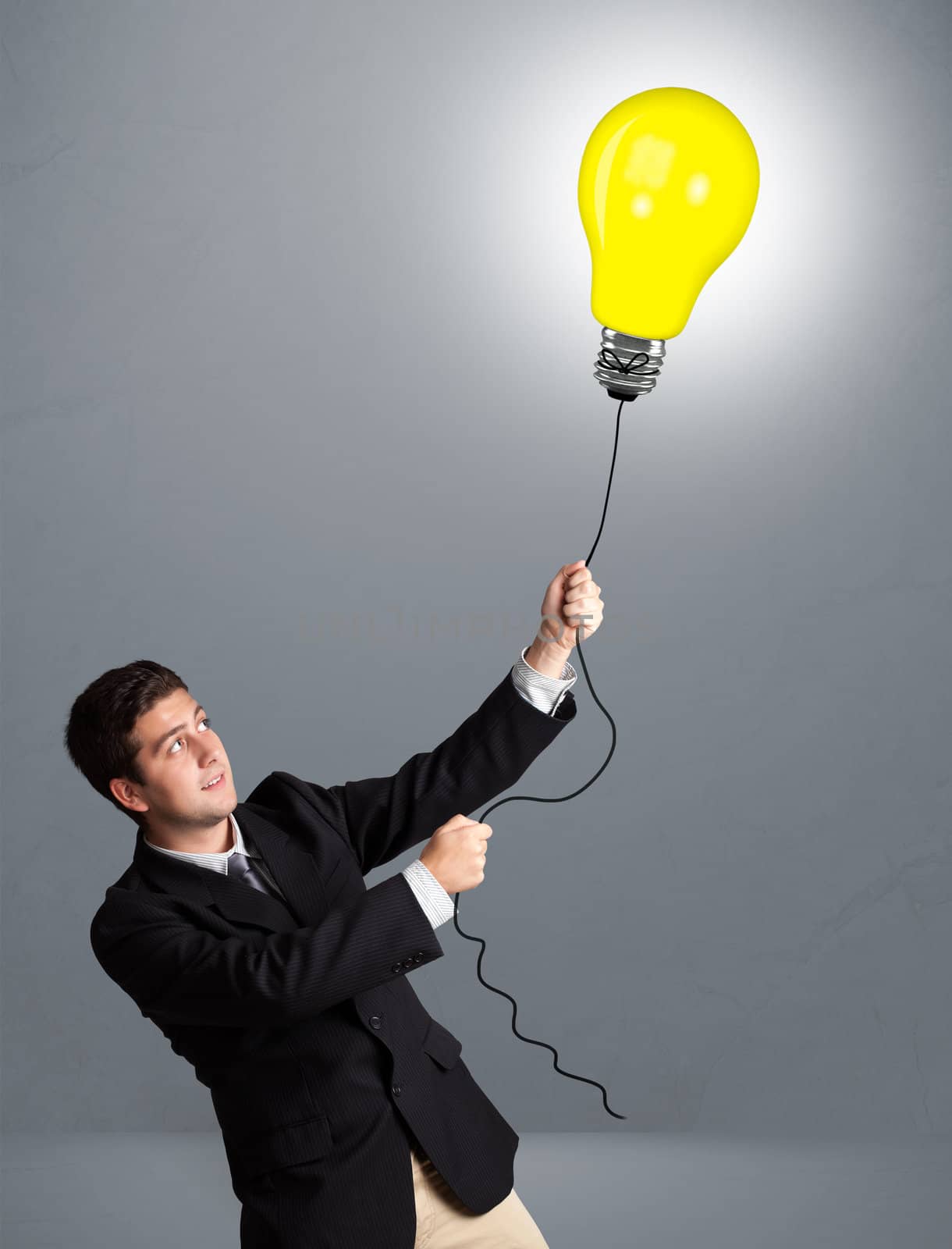 Handsome young man holding light bulb balloon