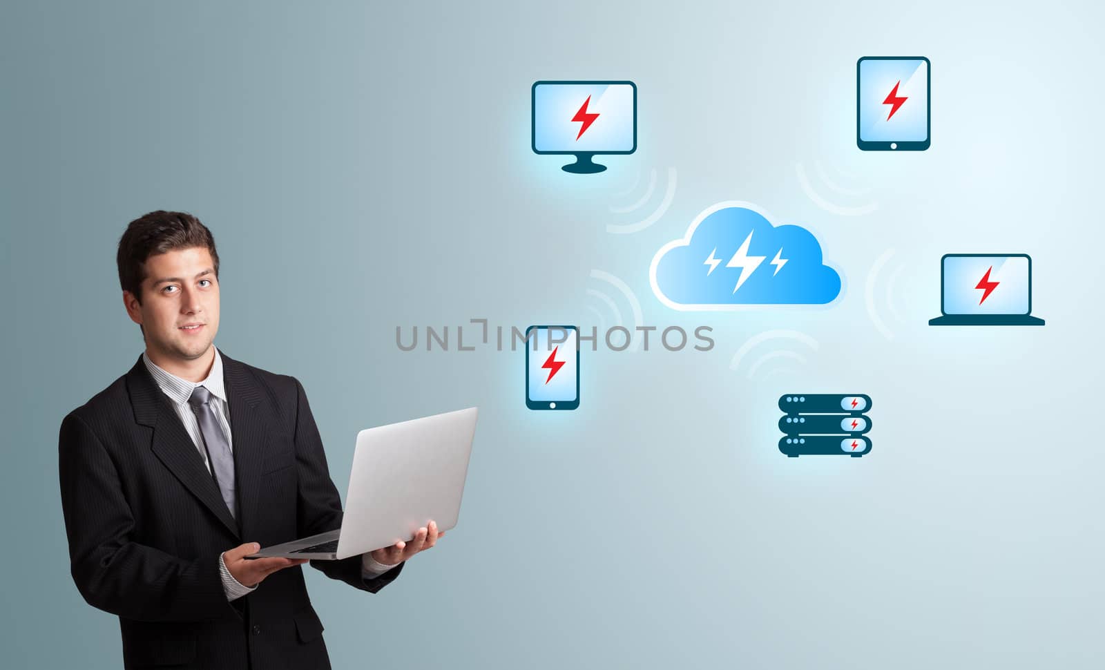 Handsome young man holding a laptop and presenting cloud computing network
