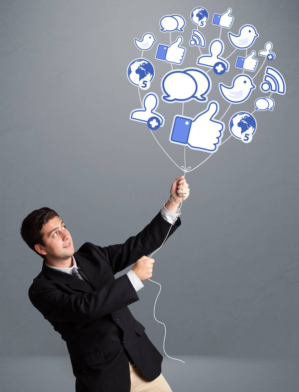 Attractive young man holding social icon balloon