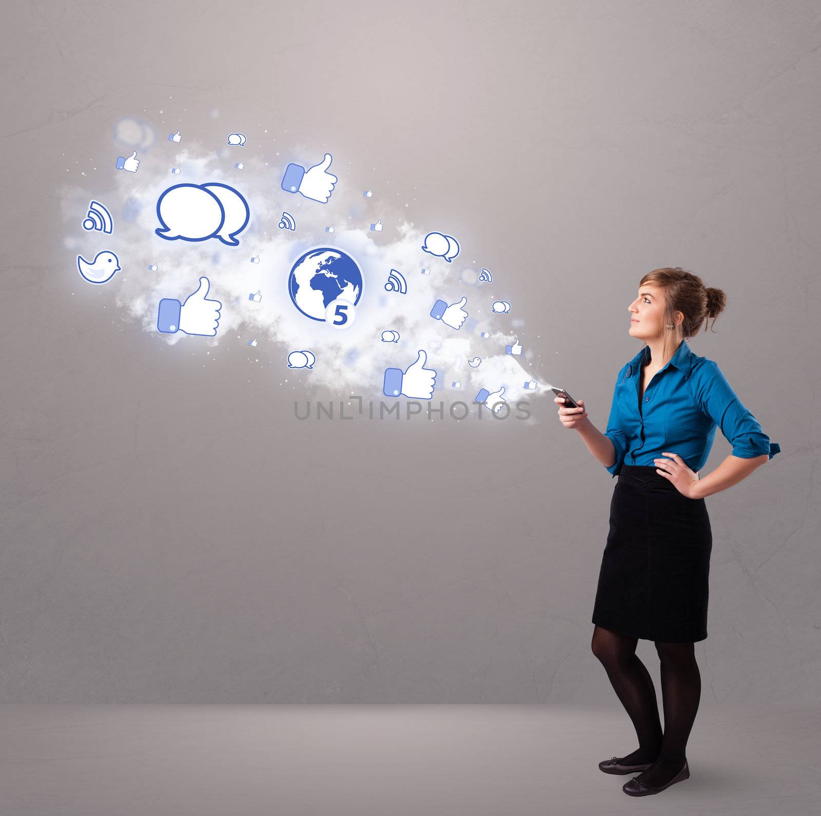 Pretty young girl holding a phone with social media icons in abstract cloud