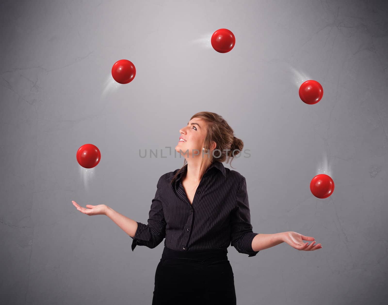 young girl standing and juggling with red balls by ra2studio