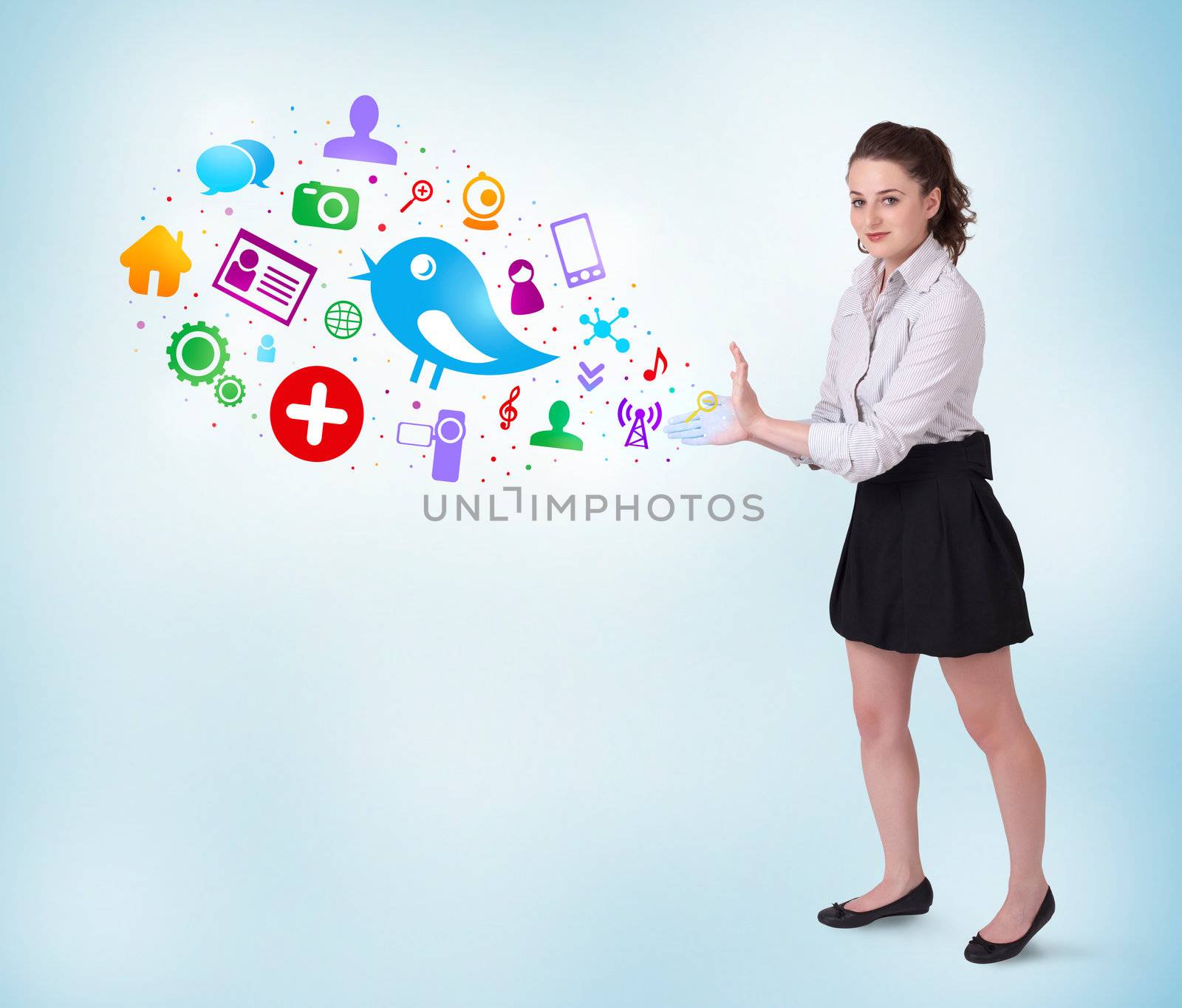 Young business woman presenting colourful social icons on bright background