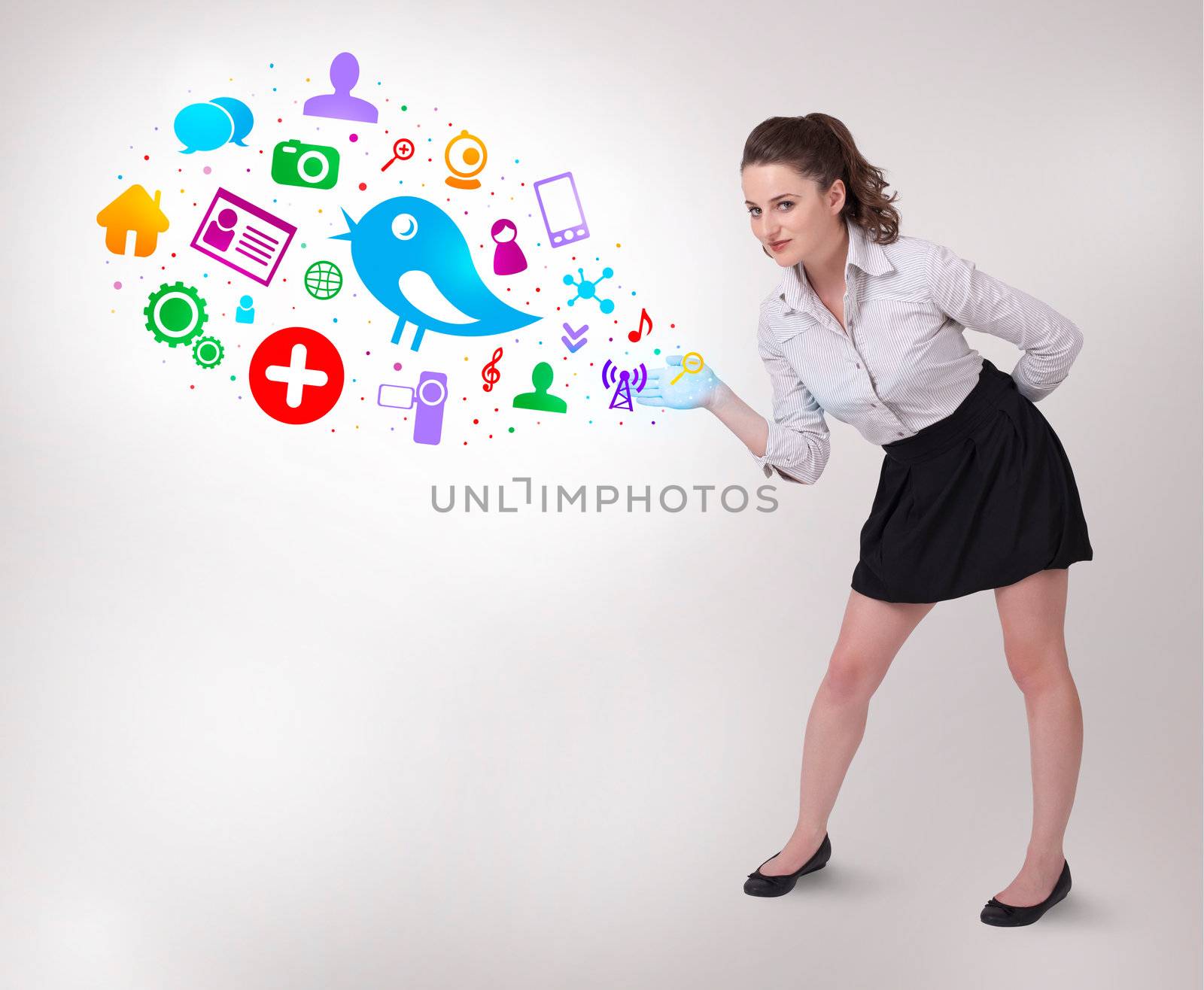 Young business woman presenting colourful social icons on bright background