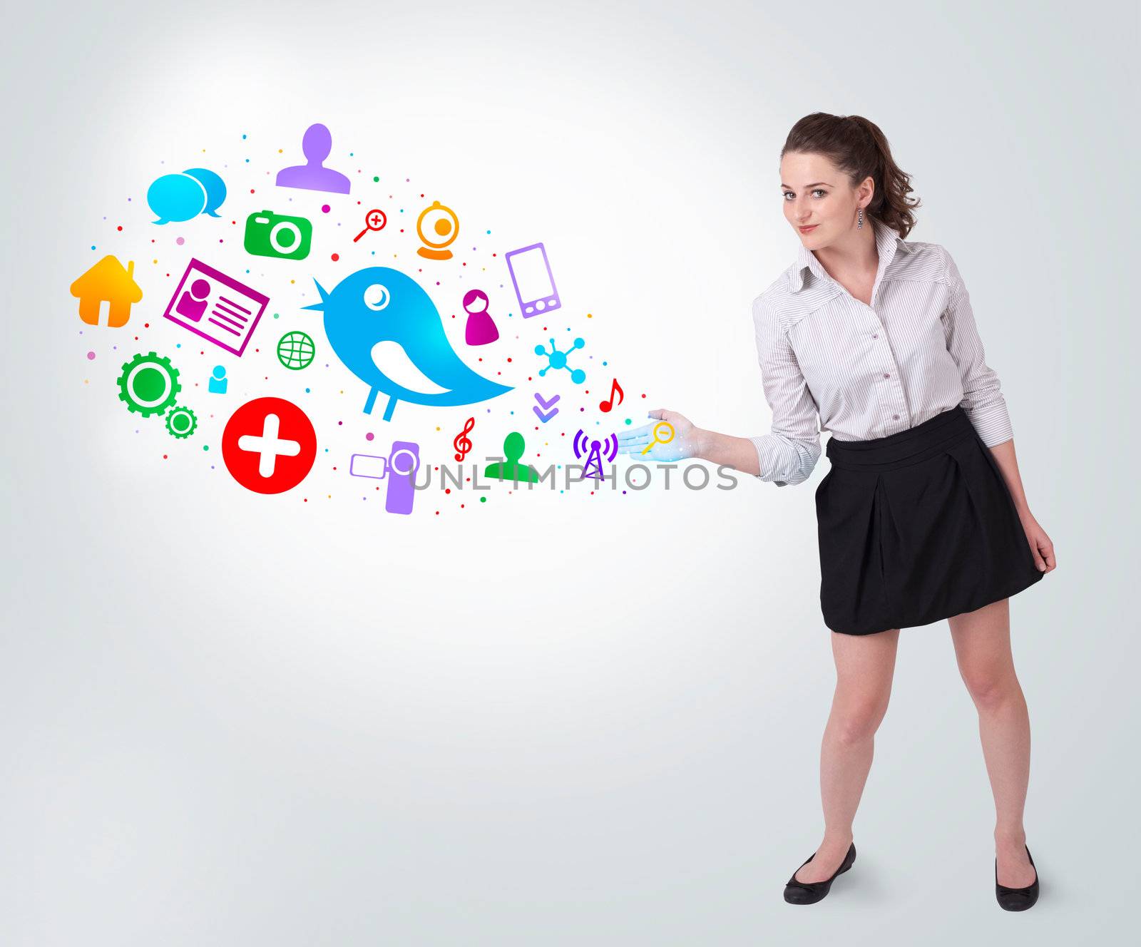 Young business woman presenting colourful social icons on bright background