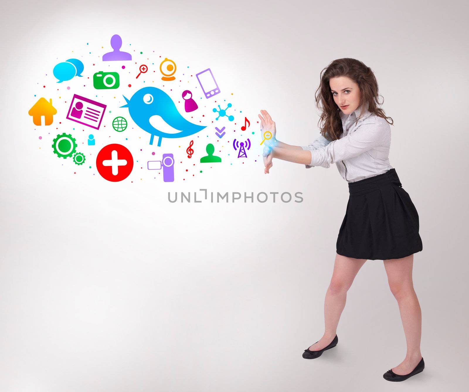 Young business woman presenting colourful social icons on bright background