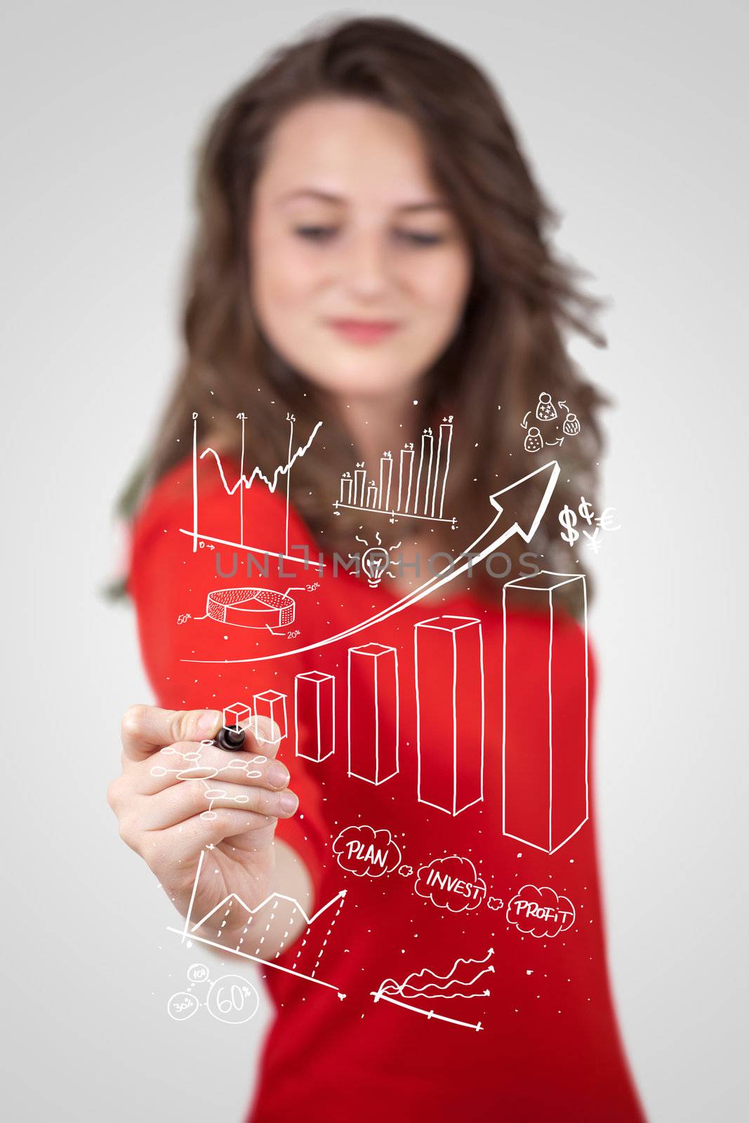 Young business woman drawing various diagrams on whiteboard